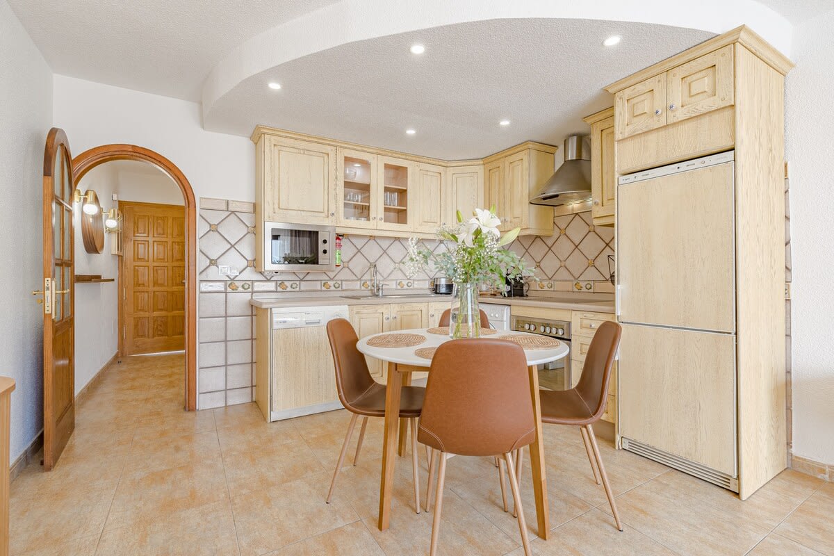 Fully Equipped Kitchen with All Appliances & Dining Area