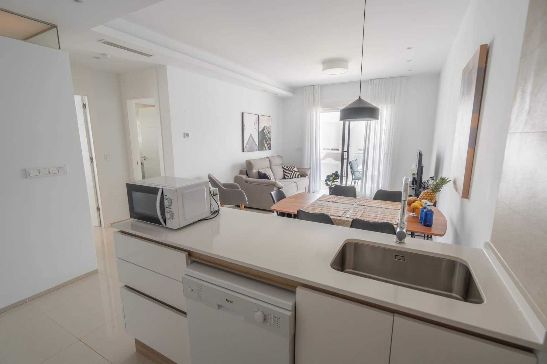 Kitchen with Dining Table, Oven, Stovetop, Microwave, Dishwasher, Fridge and Toaster