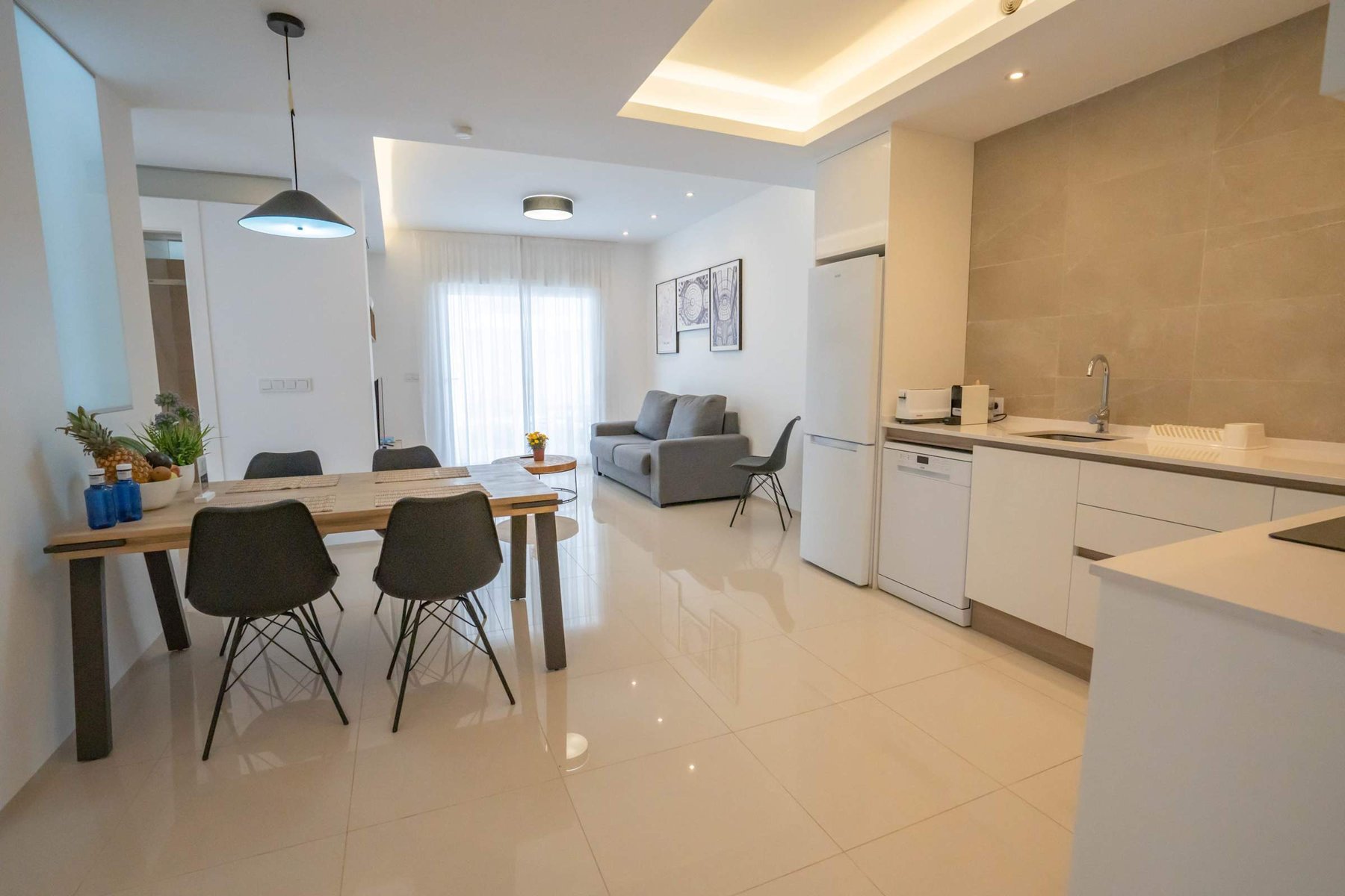 Kitchen with Dining Table, Oven, Stovetop, Microwave, Dishwasher, Fridge and Toaster