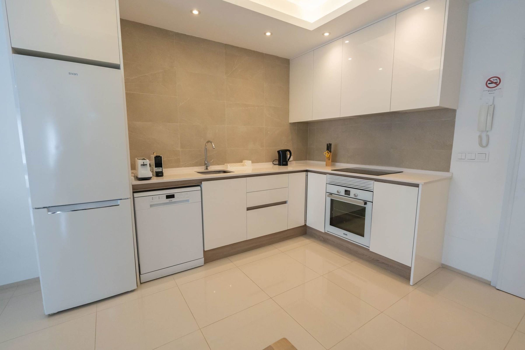 Kitchen with Dining Table, Oven, Stovetop, Microwave, Dishwasher, Fridge and Toaster