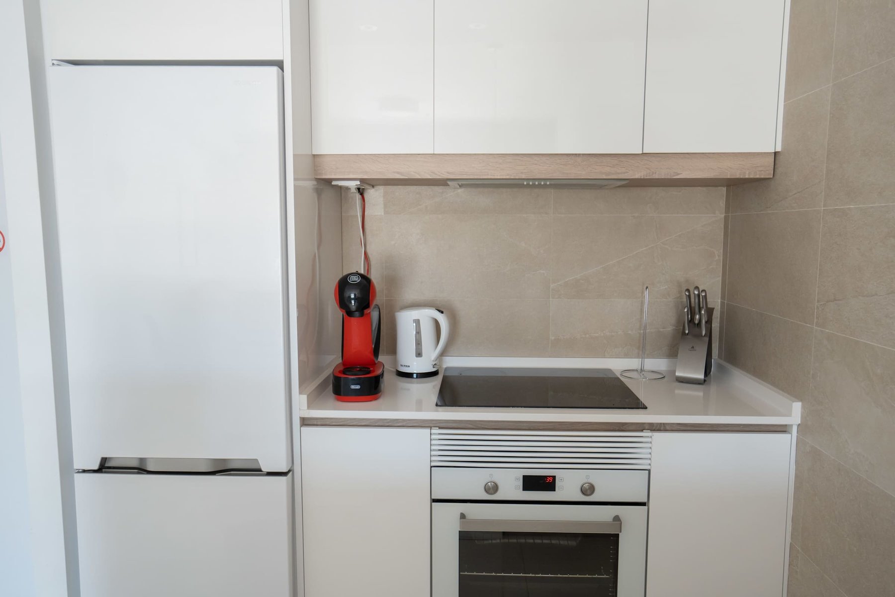 Kitchen with Dining Table, Oven, Stovetop, Microwave, Dishwasher, Fridge and Toaster
