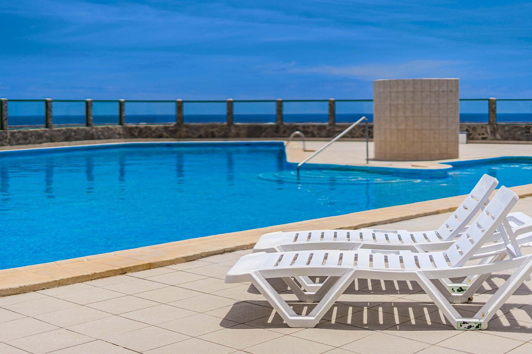 Year-Round Pool Area with Ocean Views & Sunbeds