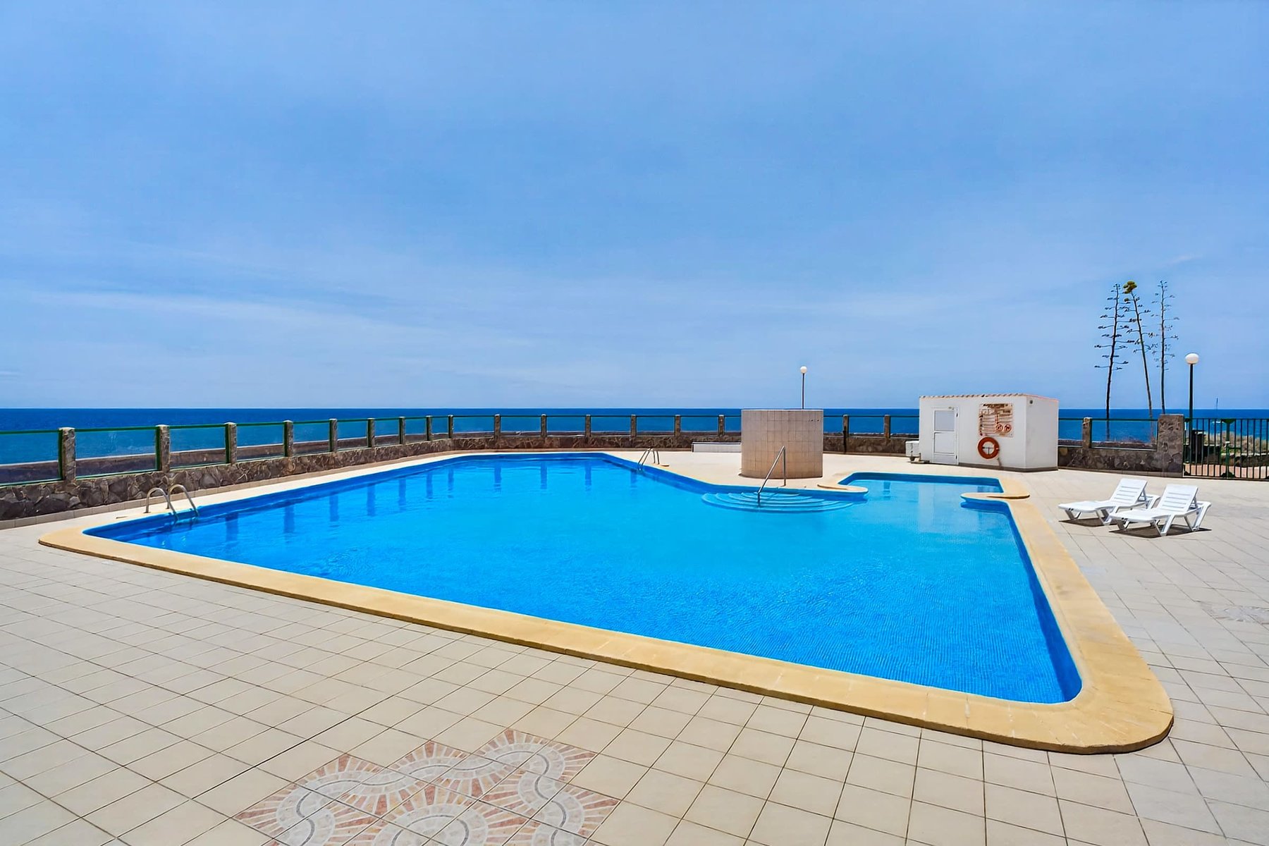 Year-Round Pool Area with Ocean Views & Sunbeds