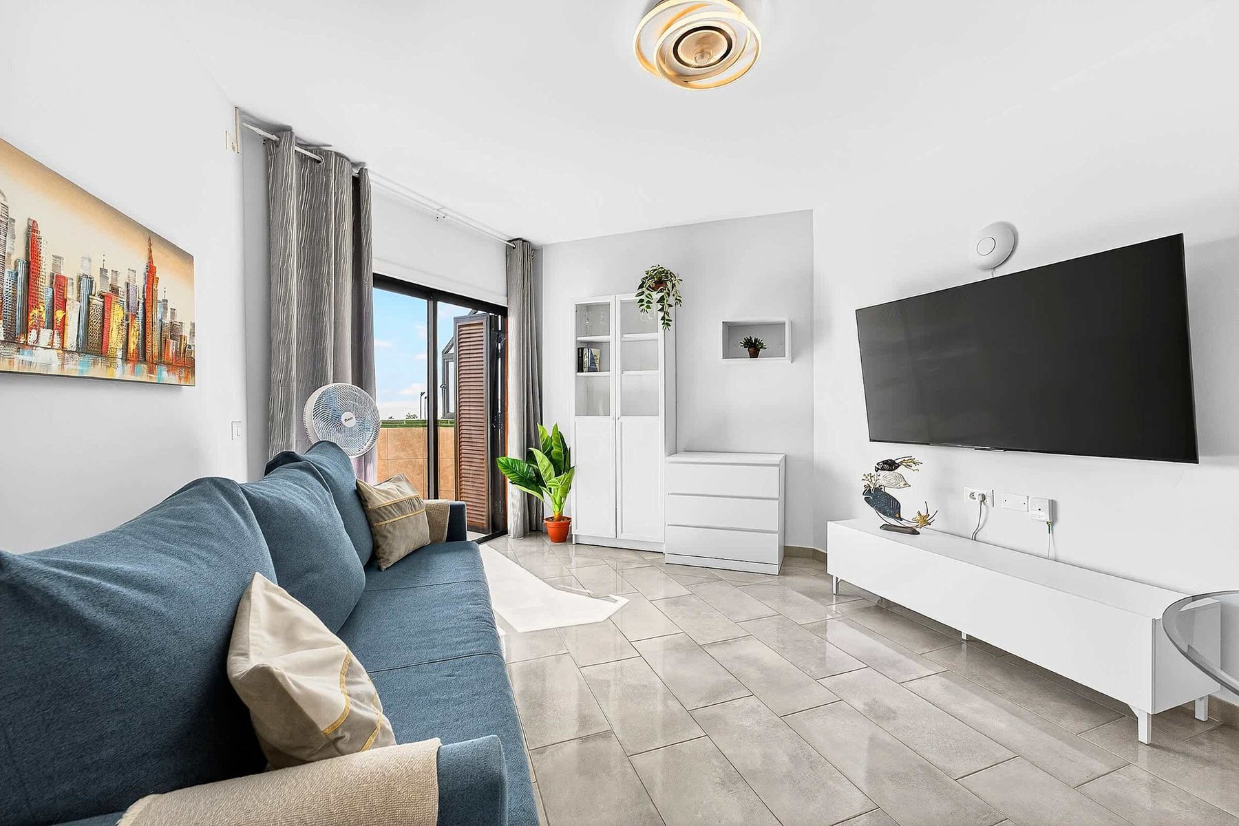 Livingroom with Dining Table, Sofa Bed, Flatscreen TV, and Balcony View
