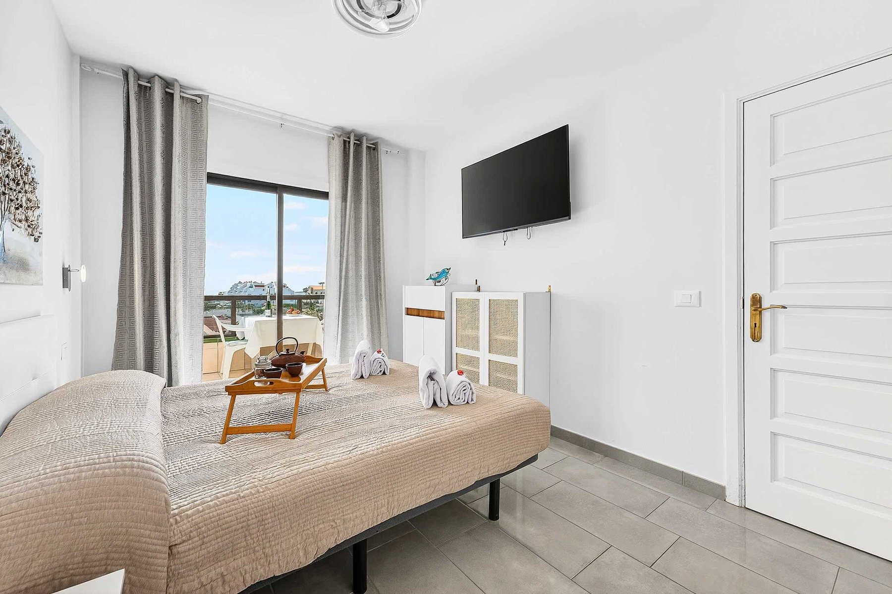 Bedroom with Queen Bed, Flatscreen TV, Wardrobe and Balcony Access