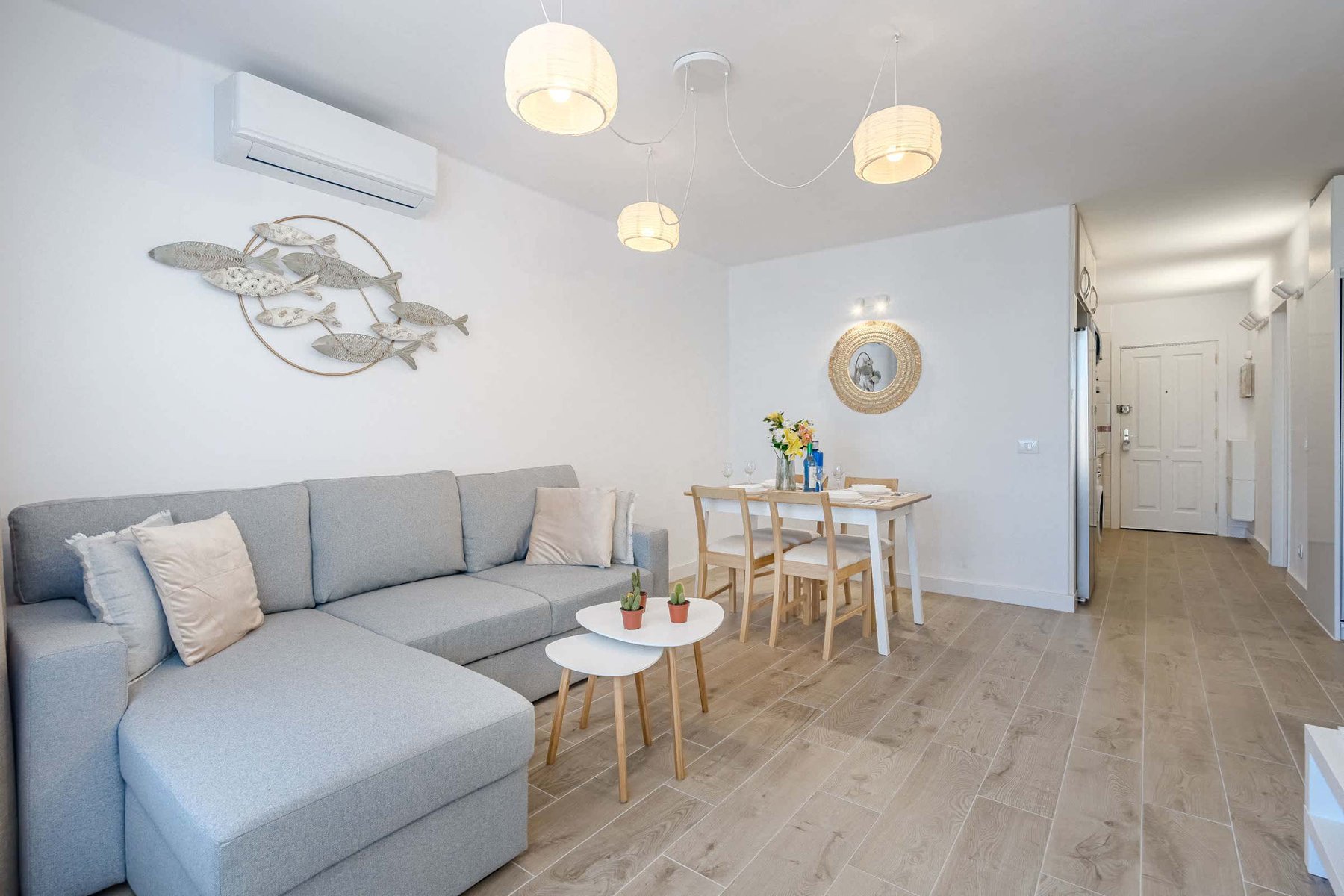 Living Room with Sofa Bed, TV, Air Conditioner, Sound System, iPad and Dining Table