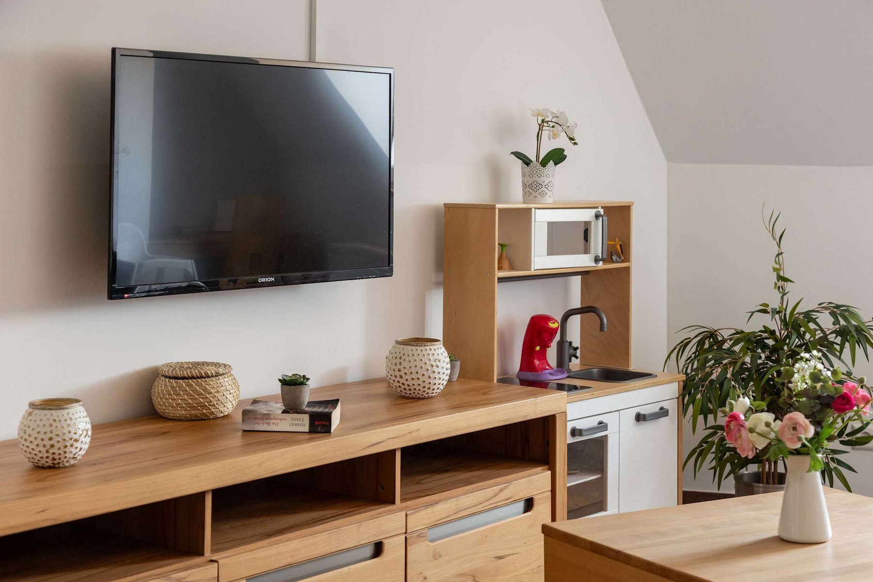 Living Area with a Dining Table, Sofa Bed, TV & Kids Play Corner