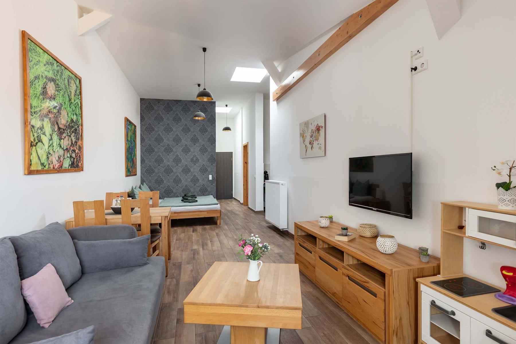 Living Area with a Double Bed, Dining Table, Sofa Bed & TV