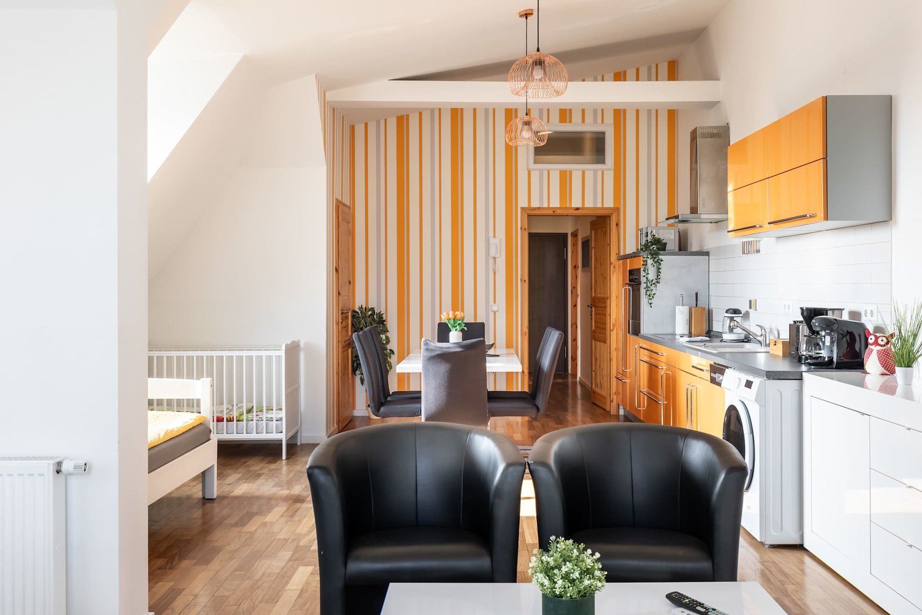 Open Kitchen & Living Area with Armchairs & Dining Table