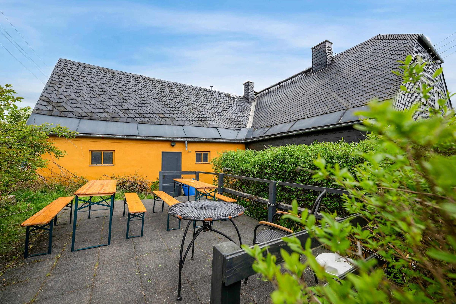 Outdoor Dining Area with picnic benches—great for meals, chats, or relaxing in the fresh air.