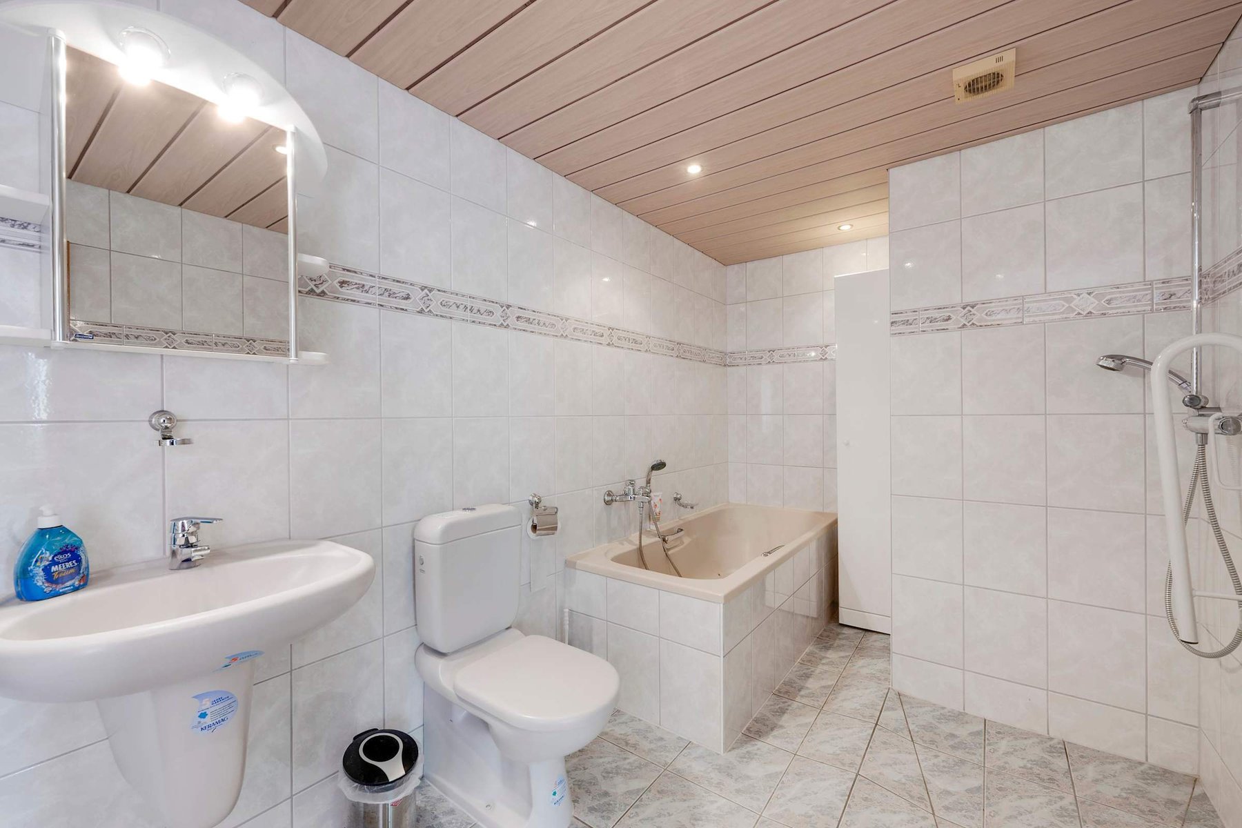 Bathroom with Bathtub, Shower, and fresh Tiled Design.