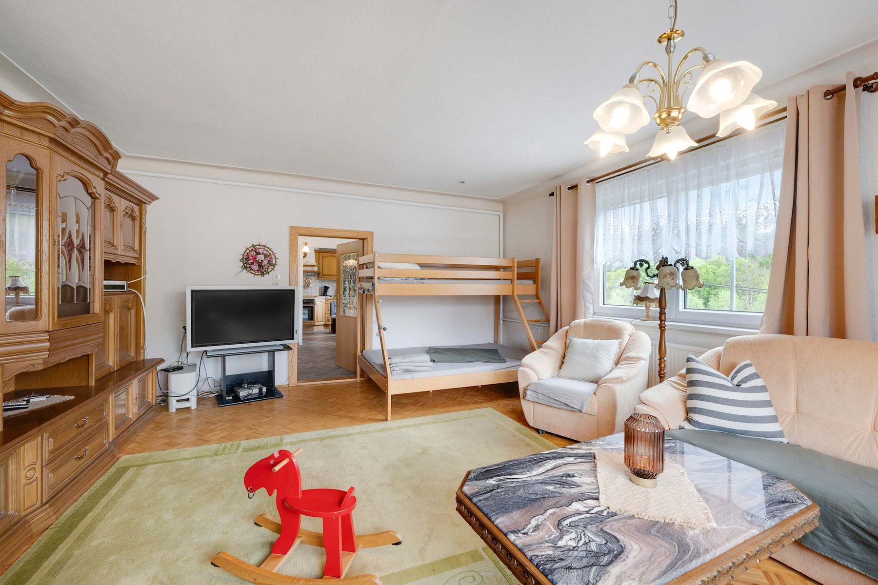 Spacious Lounge with Comfy Seating, TV, and plenty of Natural Light.