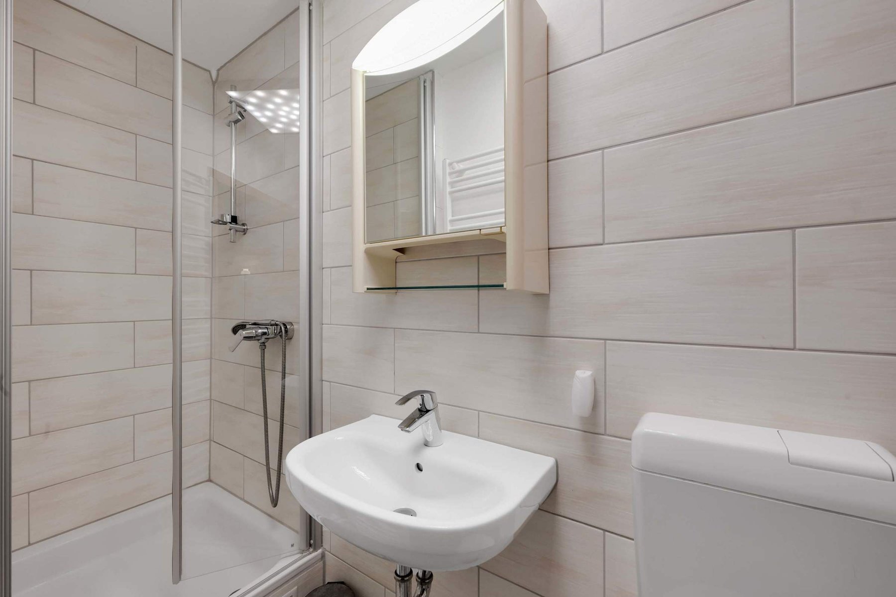 Bright Bathroom with Walk-In Shower and Mirror Cabinet.