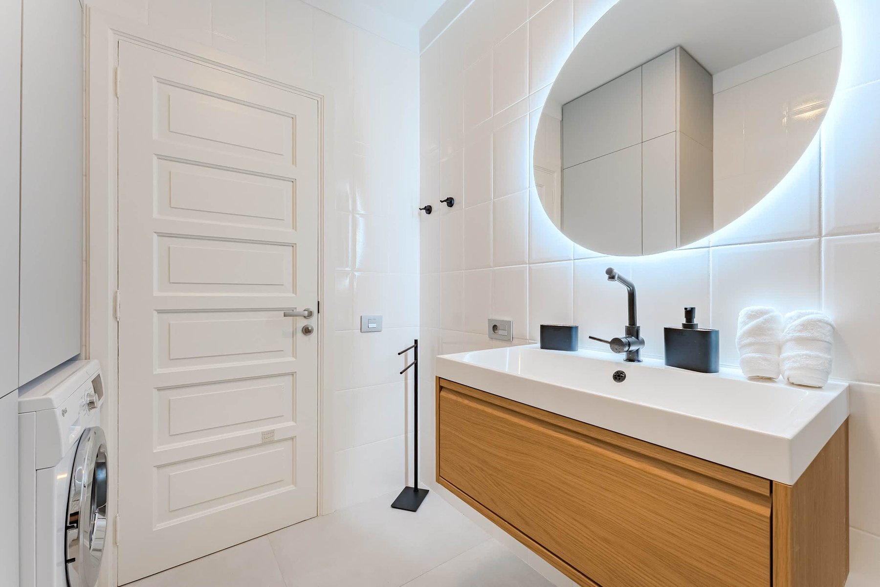 Bright, Modern Bathroom with Backlit Vanity Mirror, Designer Fixtures & Premium Towels
