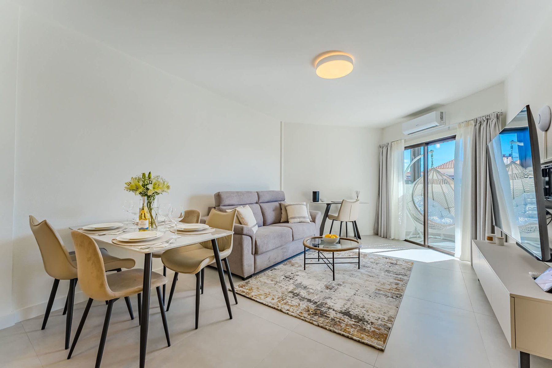 Bright Oceanfront Living Room with Designer Sofa, Oversized Flatscreen TV, Apple TV, Sonos Sound System & Elegant Workspace