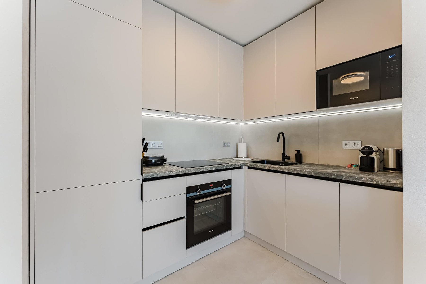 Fully Equipped Custom Kitchen with High-End Appliances, Nespresso Machine & Integrated Cabinetry for Seamless Design

