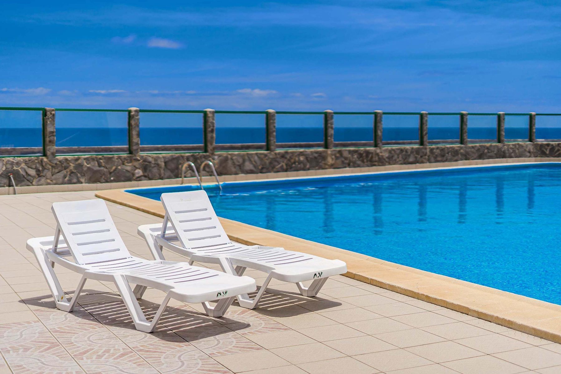 Year-Round Pool Area with Ocean Views & Sunbeds 
