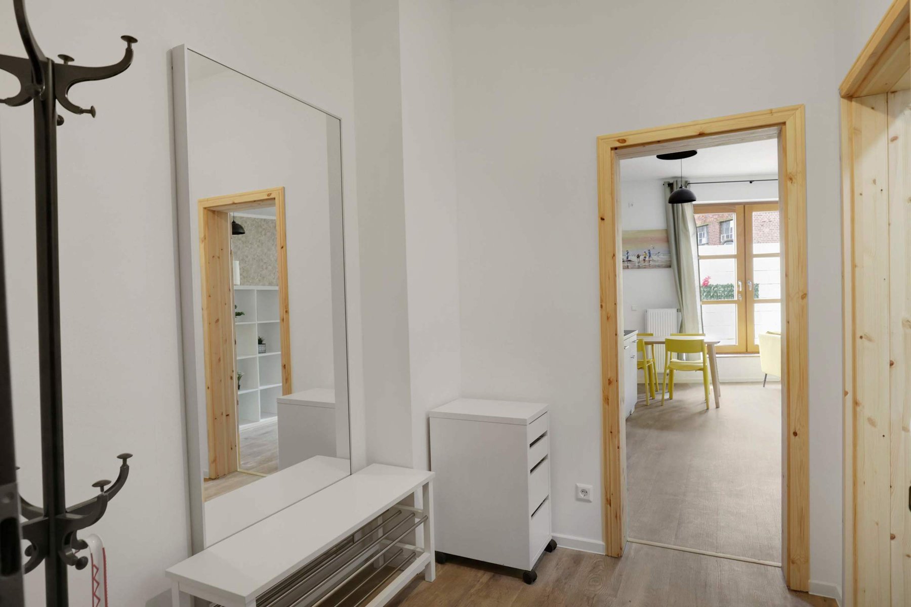 Entryway with mirror | Functional hallway space with coat rack and bench