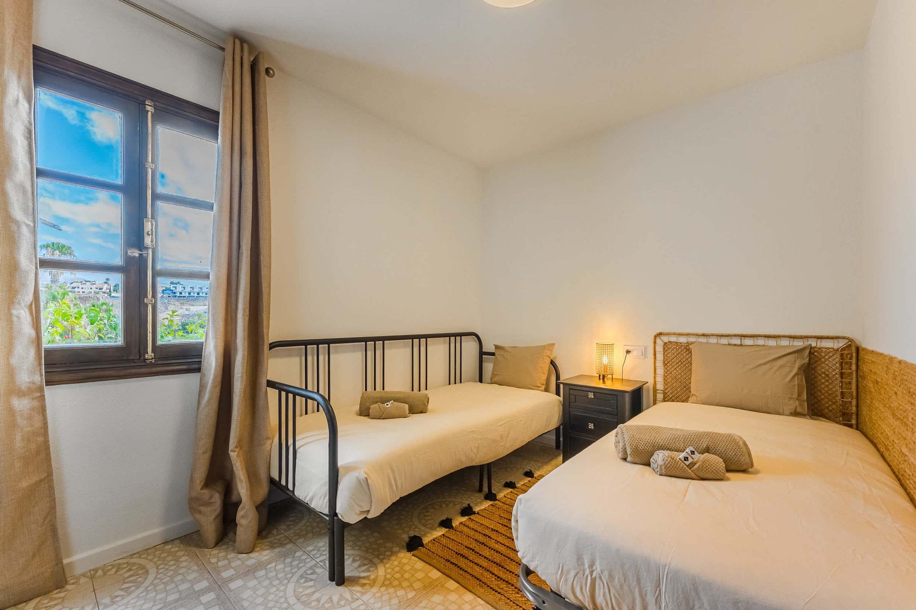 Second Bedroom with Two Single Beds — Ideal for Kids, Friends, or Extra Guests, Framed by a Bright Window and Cozy Natural Decor