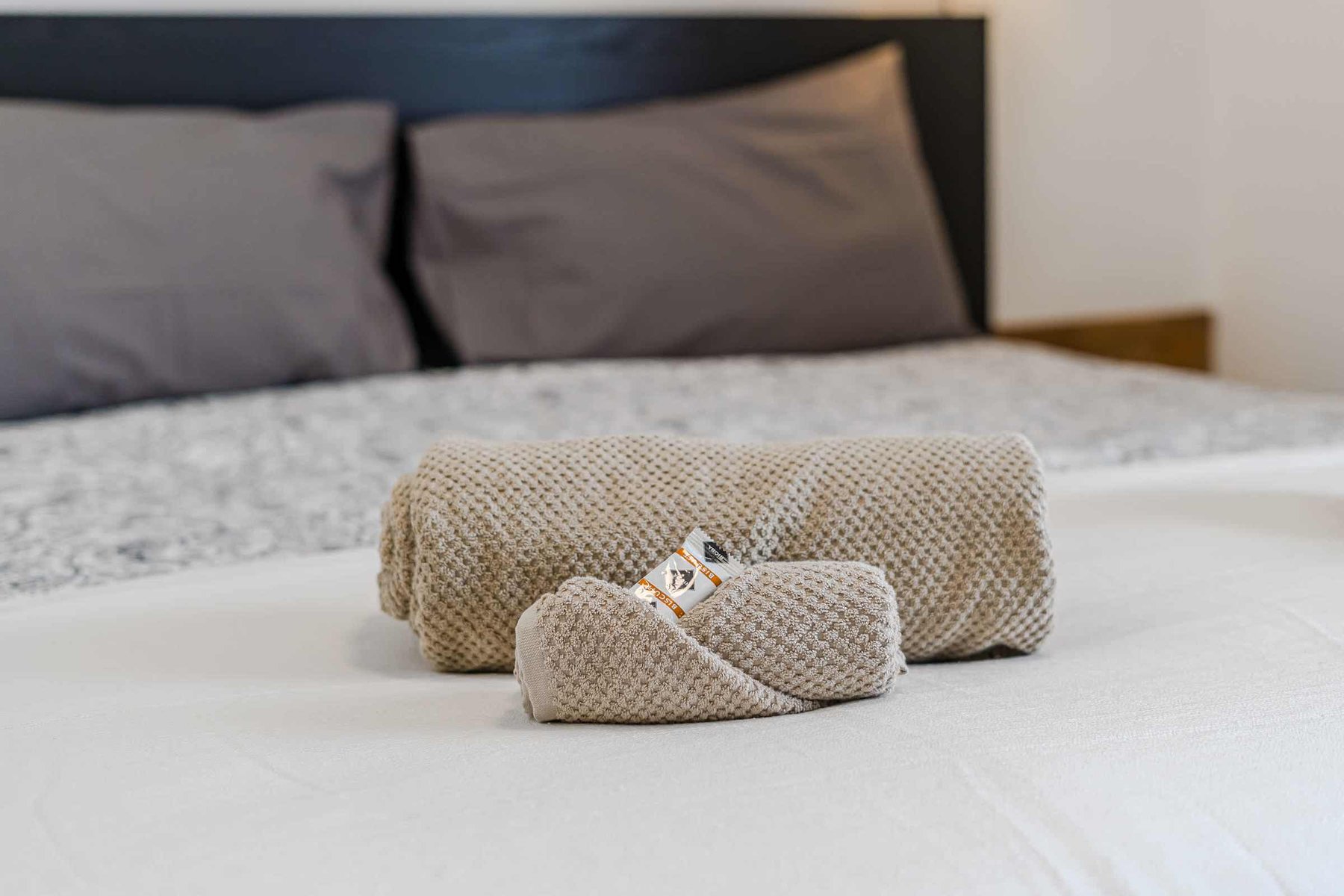 Fresh Towels Rolled & Ready — Crisp Linens and Spa-Like Details Await You in the Master Bedroom of the Duplex Suite