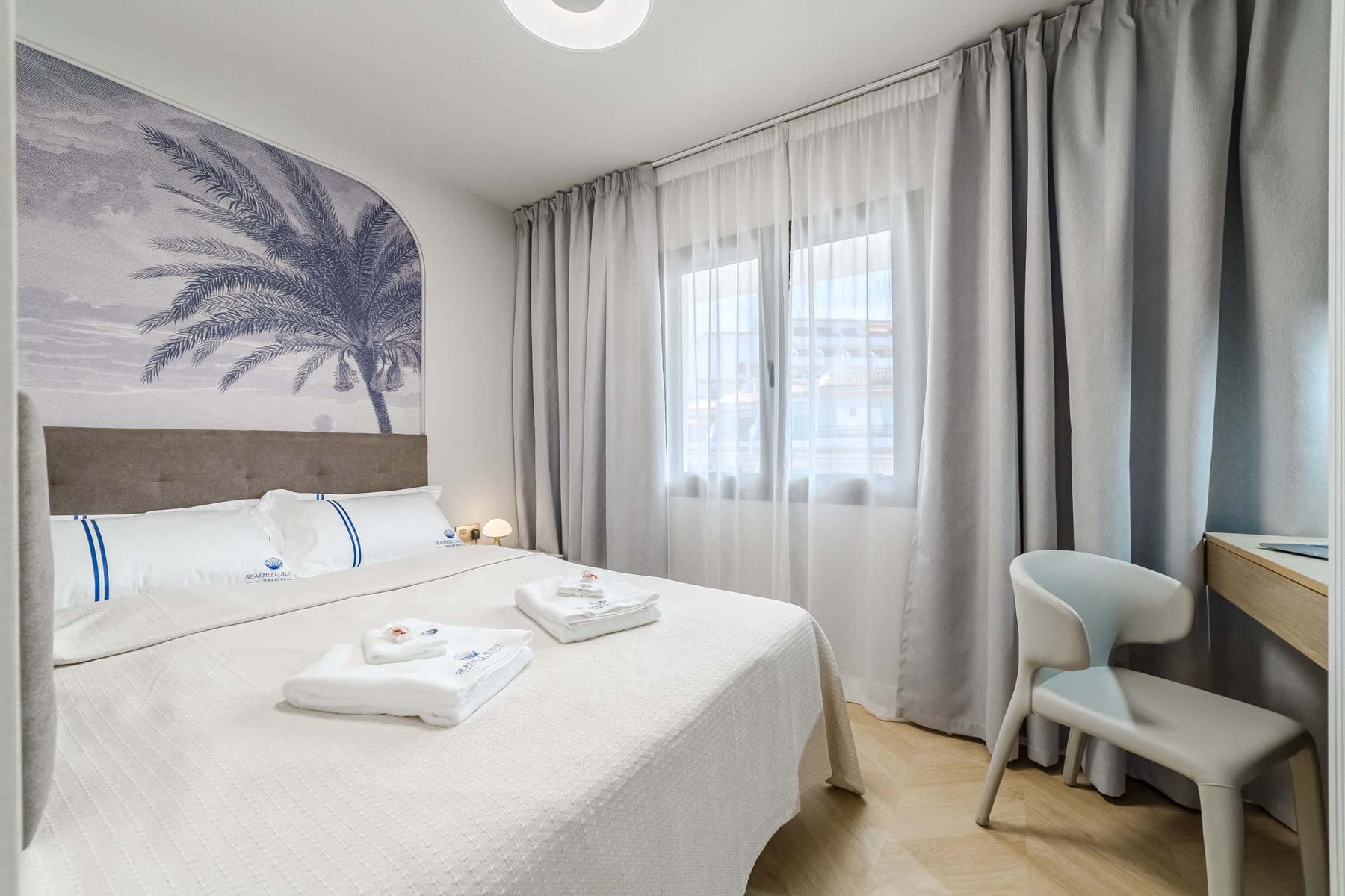 Stylish Bedroom with Palm-Inspired Accent Wall – Wake Up in Coastal Elegance
