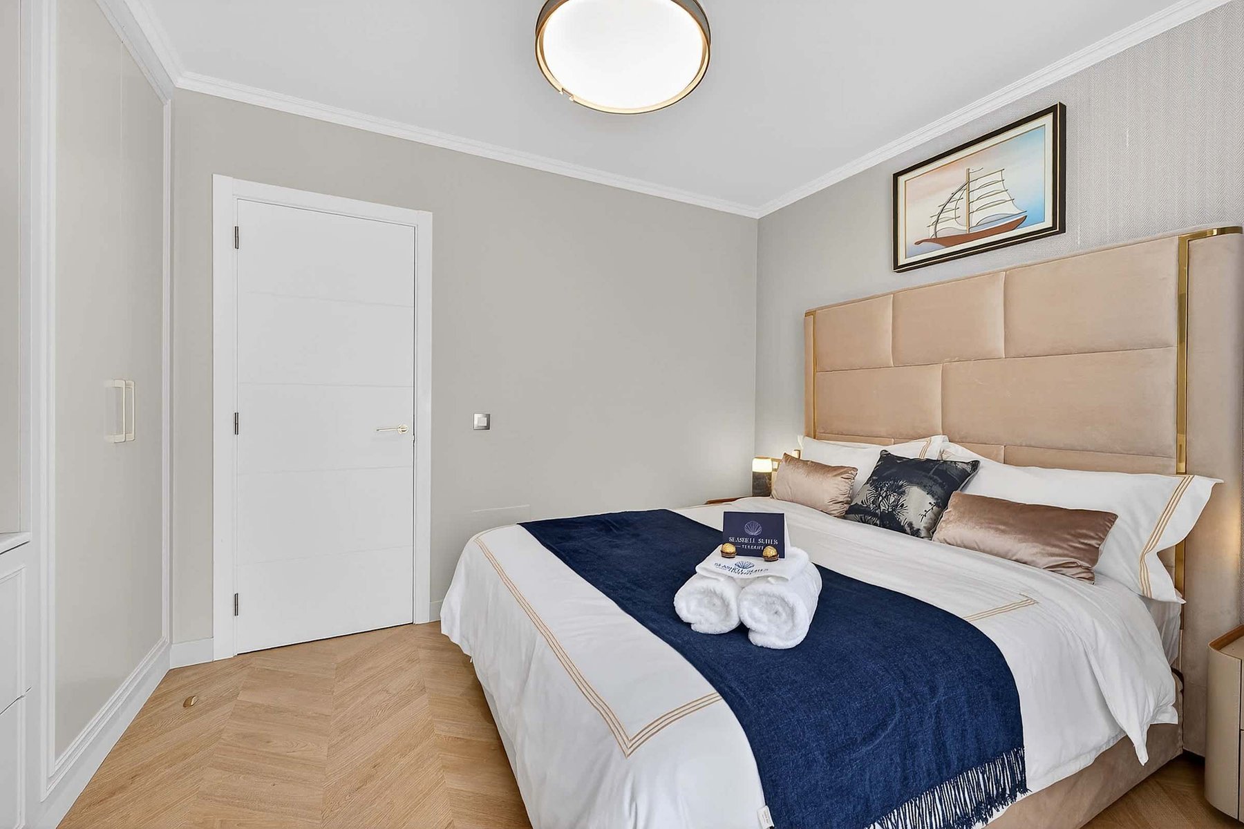 Tranquil Second Bedroom with Sea-Inspired Tones — Wake Refreshed in a Coastal Retreat with Soft Drapes and Plush Bedding