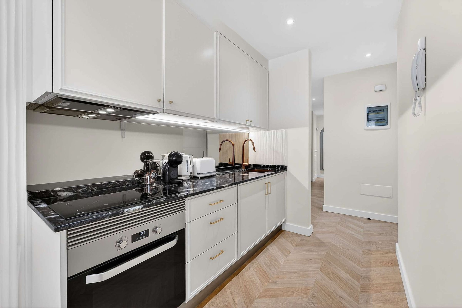 Sleek Marble Kitchen and Designer Fixtures – Cook and Dine in Style with Gold Accents and Luxe Appliances