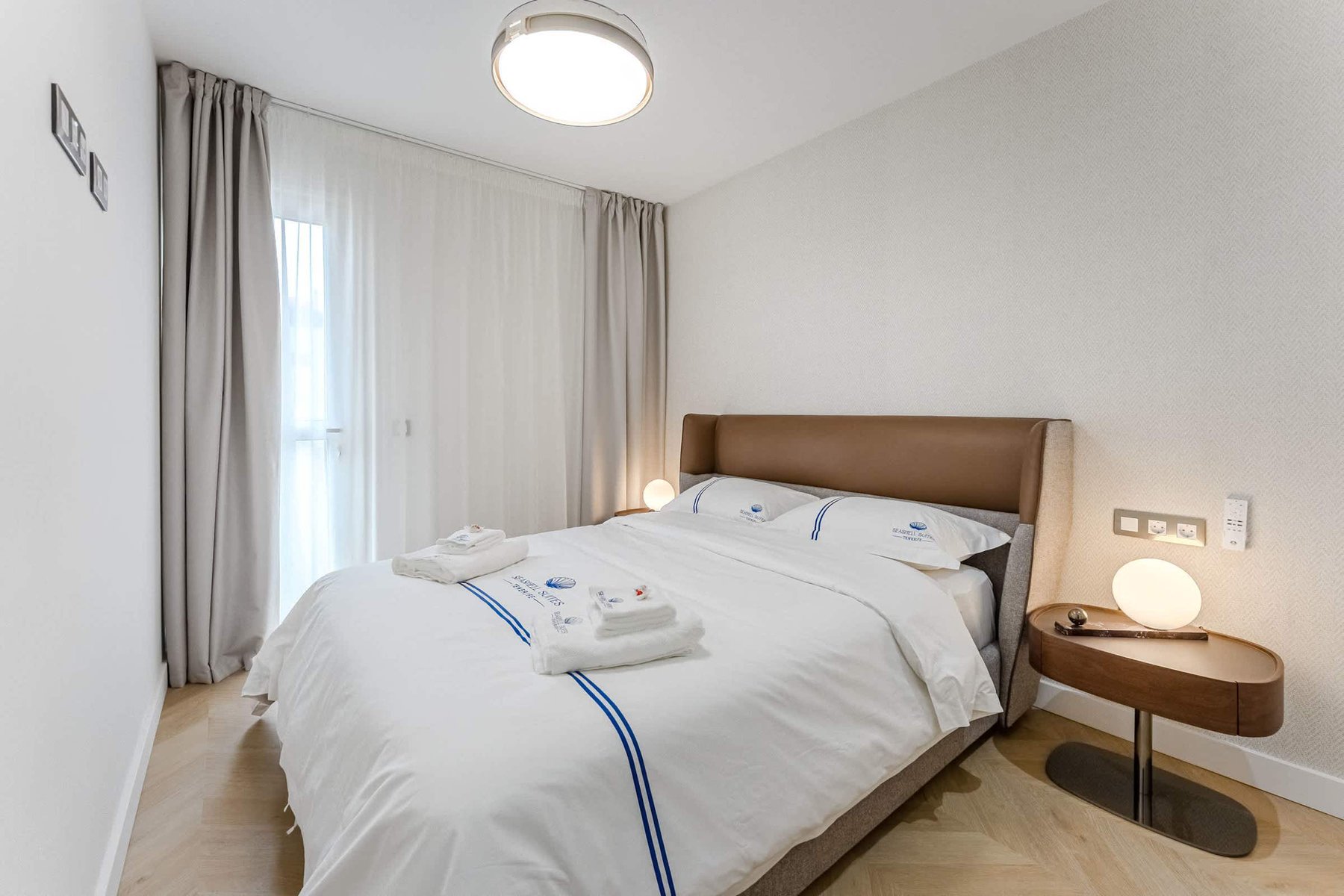Serene Master Bedroom with Balcony Access and Luxe Linens – Boutique Calm by the Coast