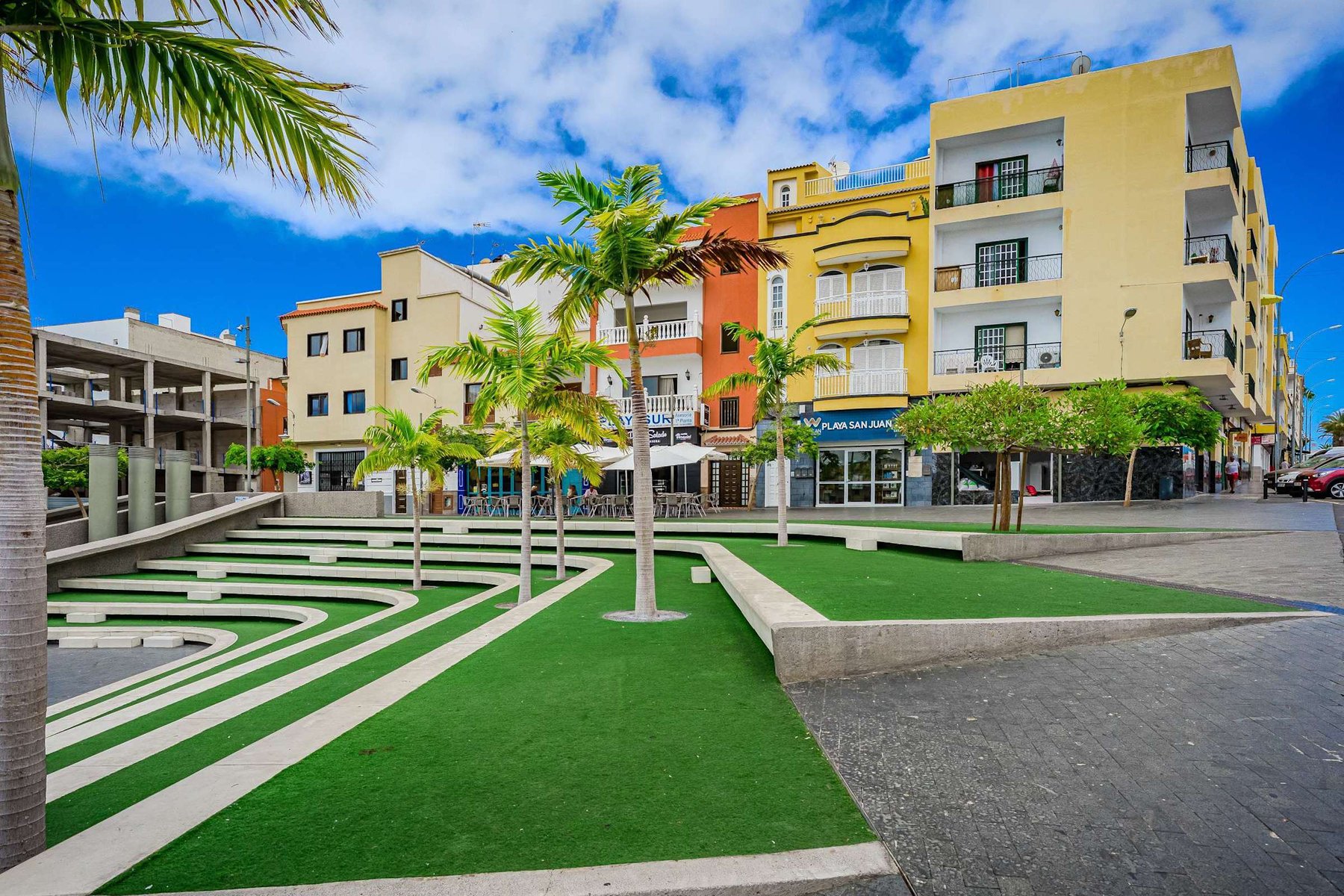 Colorful Plaza with Cafés and Local Shops in Playa San Juan – Moments from Your Stay