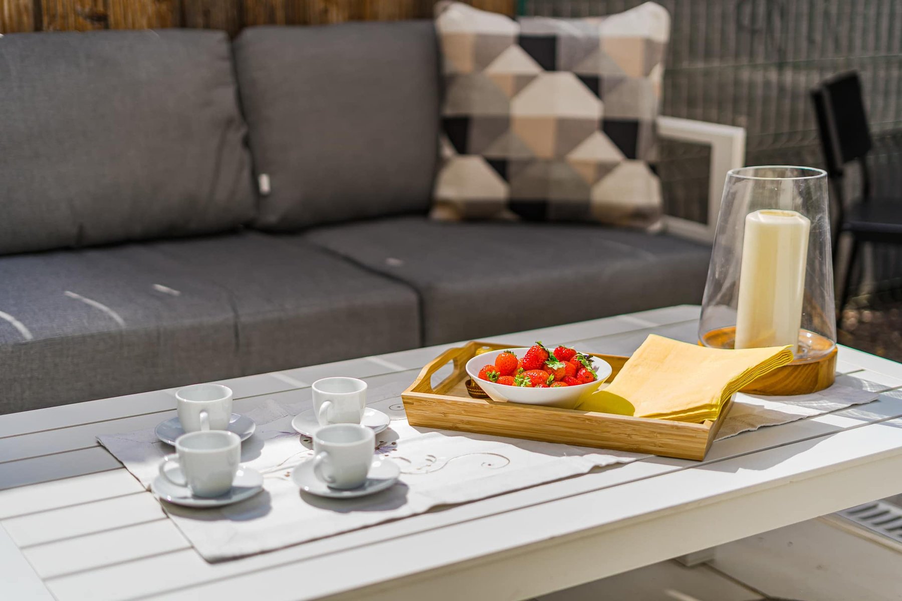 Inviting Outdoor Lounge Moment with Strawberries and Espresso – A Simple Pleasure on the Sun-Dappled Private Patio