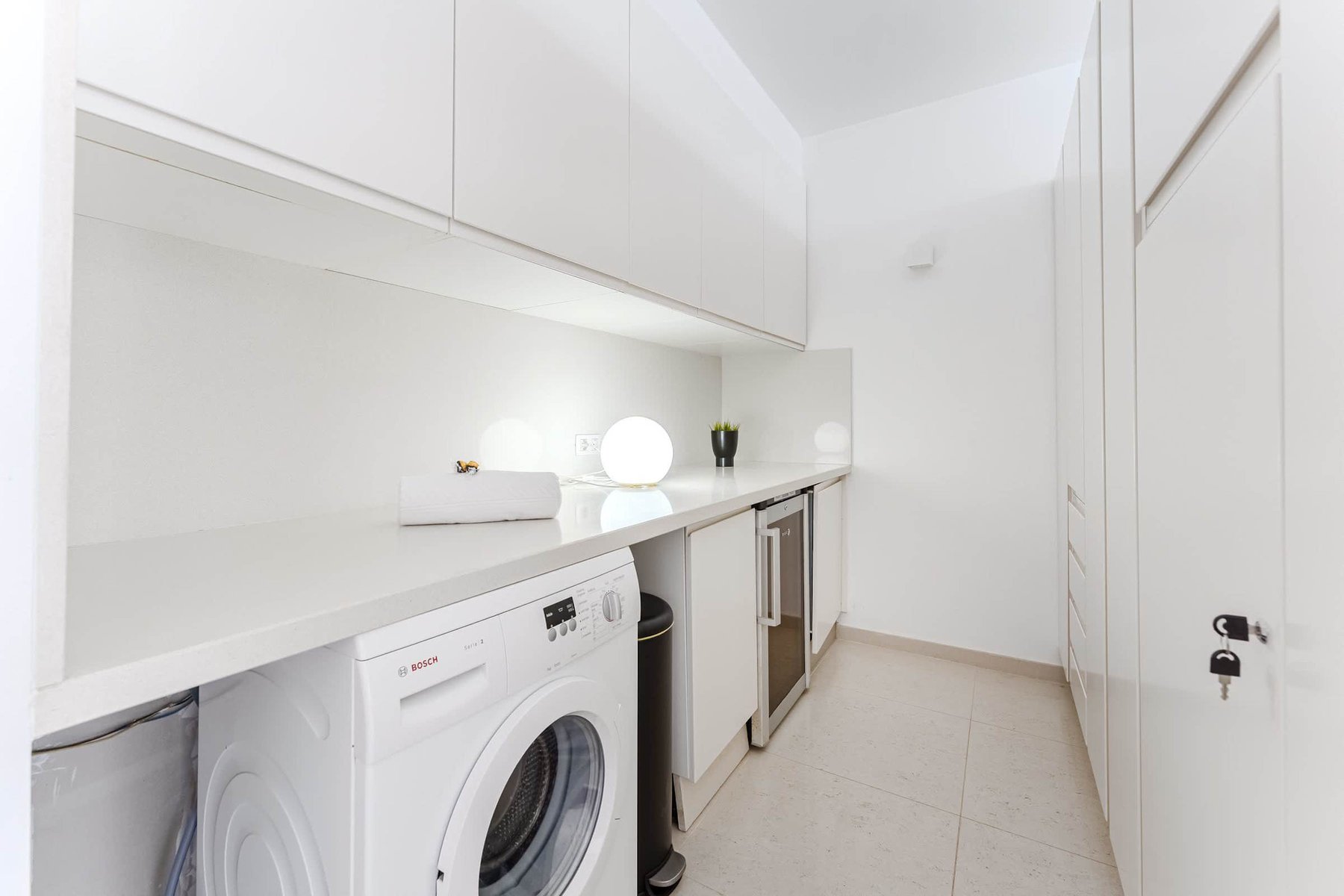 Dedicated Laundry Area with Washer, Wine Fridge, Ample Storage, and LED Mood Lighting