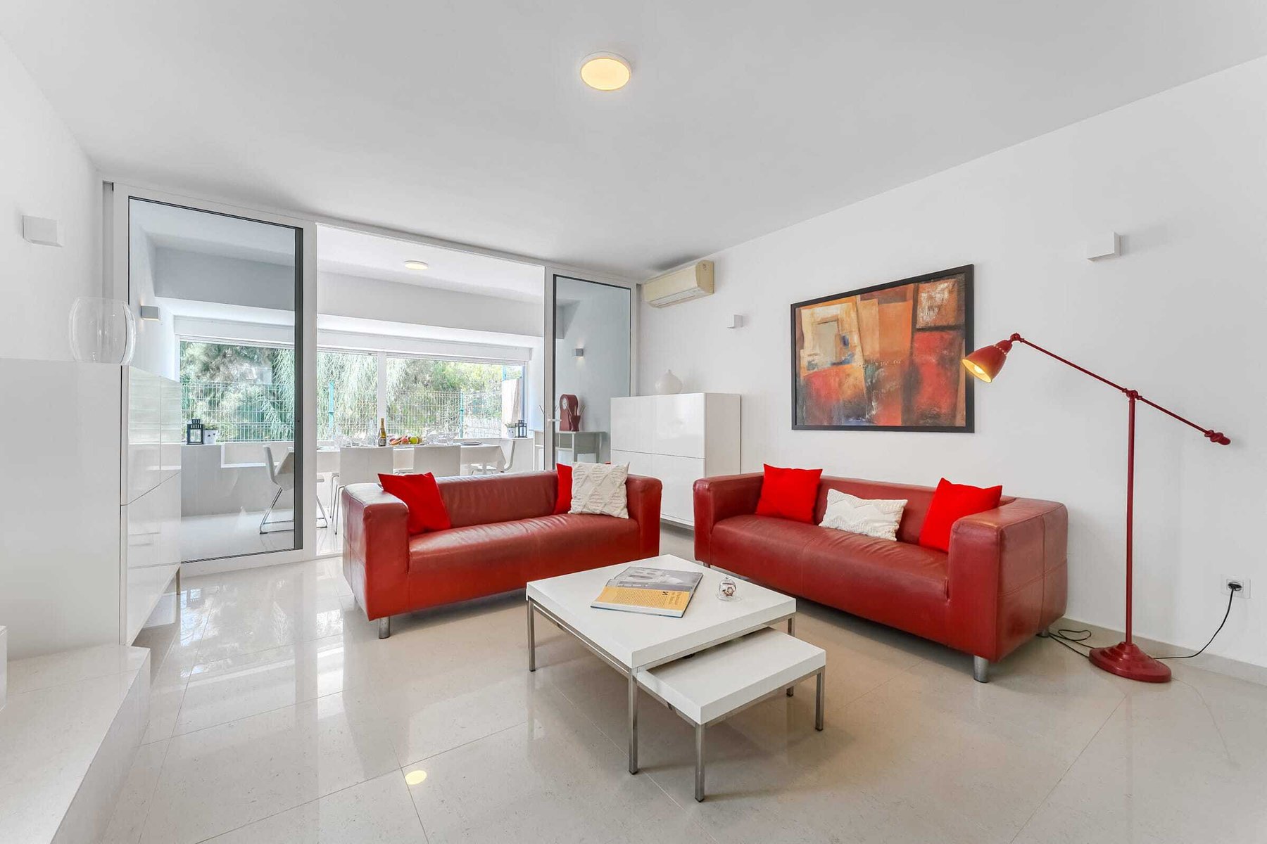 Modern Open Living Room with Glass Sliding Doors, Artful Touches and Garden Views