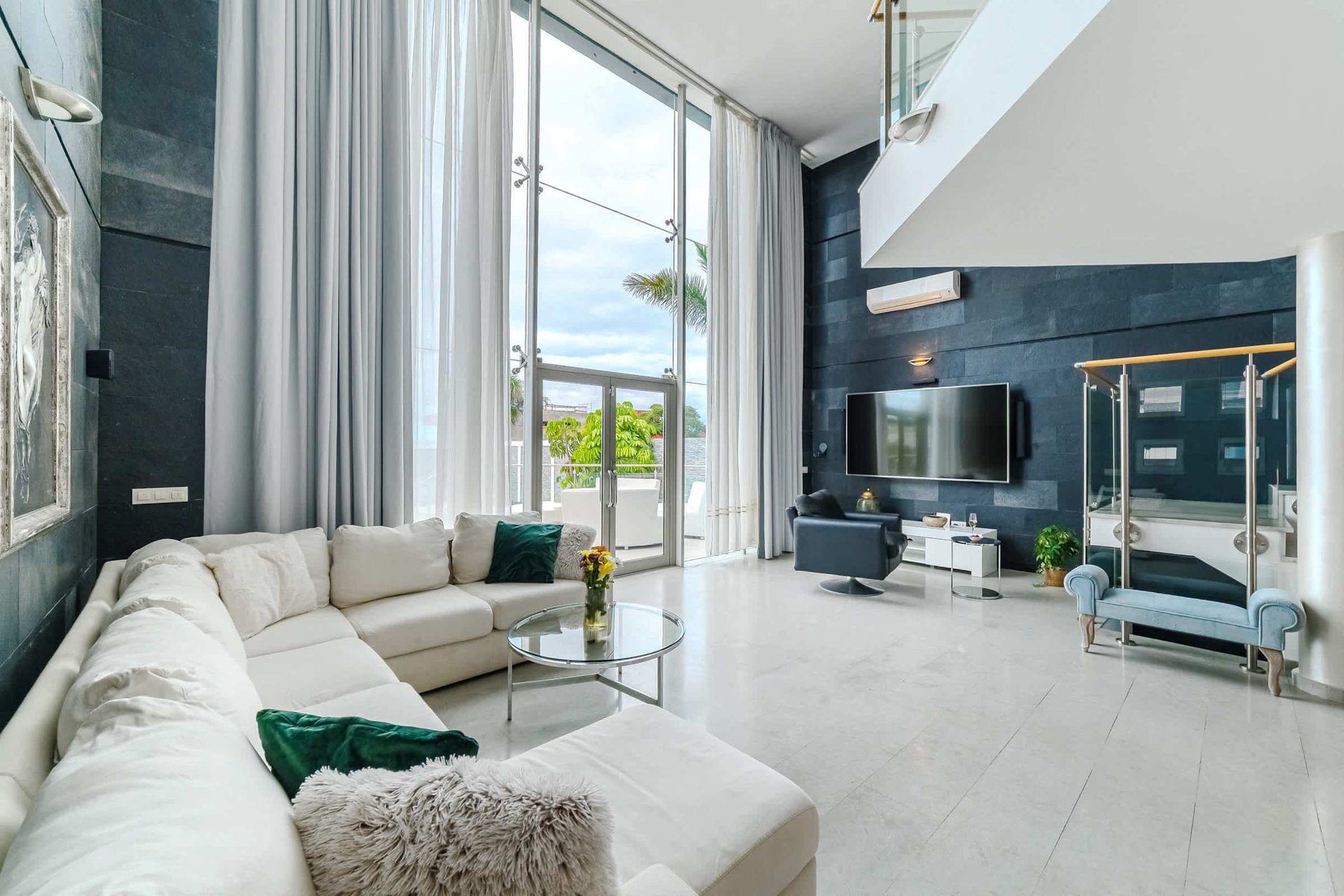 Spacious Designer Living Room with Soaring Ceilings - Unwind in Style with Smart TV, Plush Sofa, and Indoor-Outdoor Flow