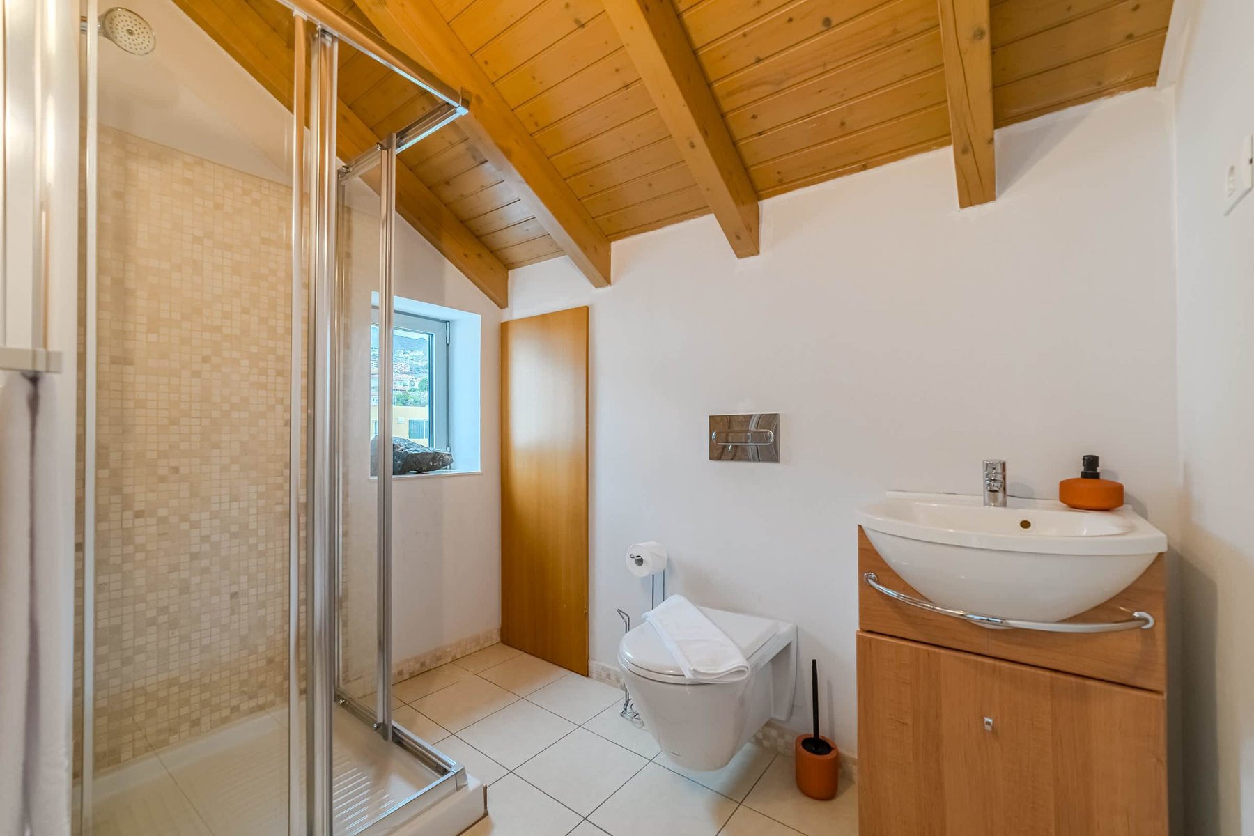 Charming Top-Floor Bathroom with Skylight - Rustic Wooden Ceilings and a Fresh Spa-Like Atmosphere