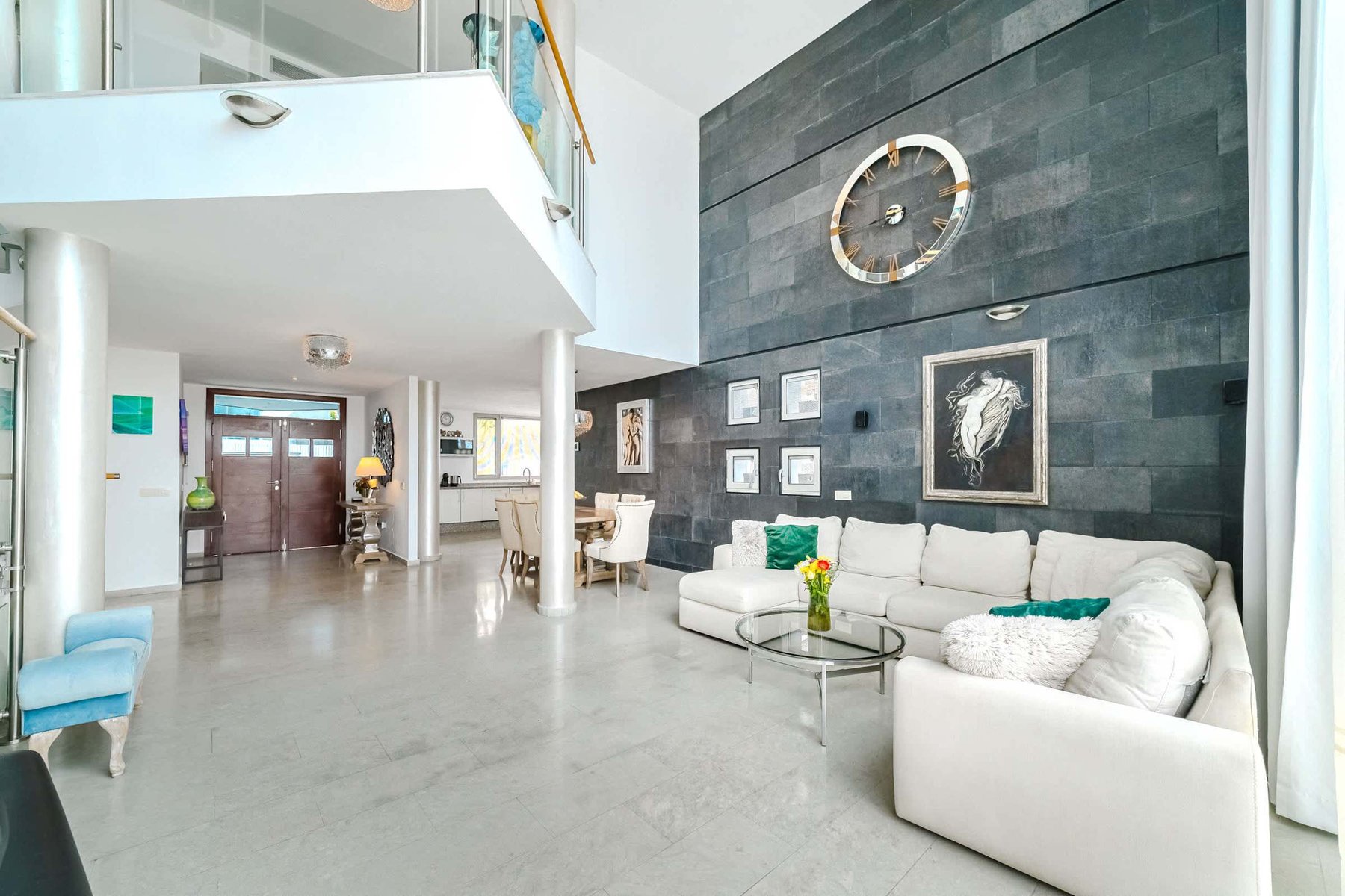 Stylish Double-Height Living Room - Contemporary Comfort with Grand Clock Feature Wall and Chic Interior Design