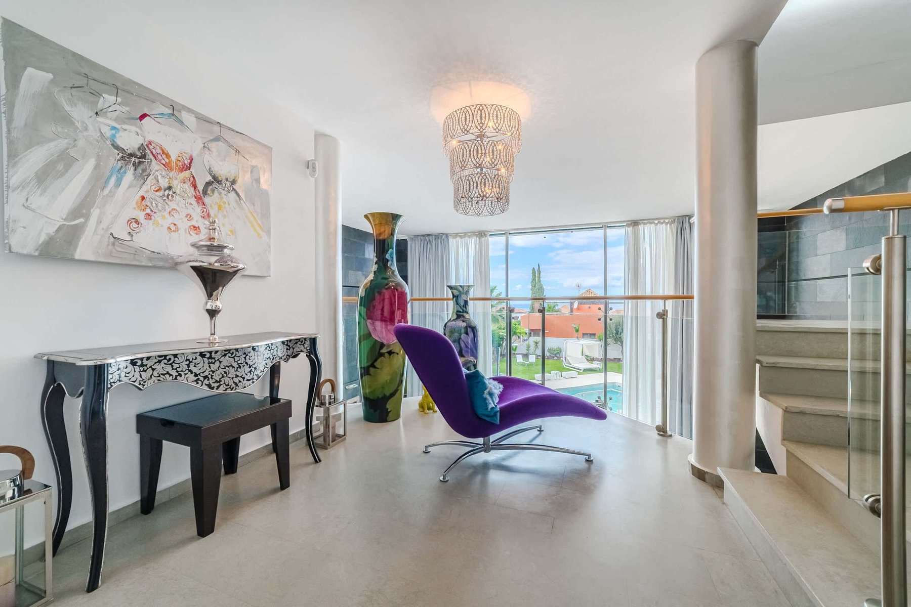 Artful Upper-Level Lounge with Statement Design - A Bold and Bright Spot to Read, Relax, or Enjoy the Pool View