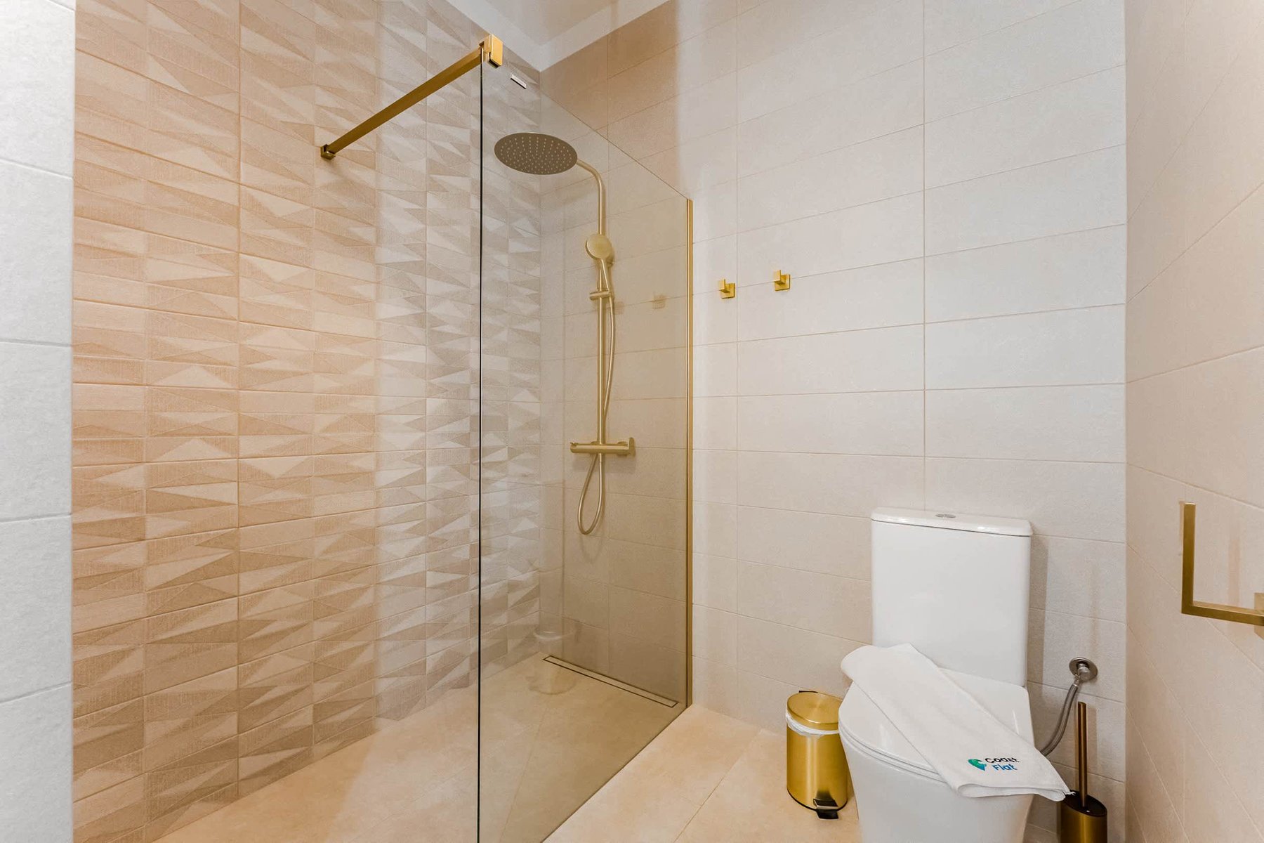The Golden Luxury En-Suite Bathroom with Shower, WC, Sink, Washing Machine and all Amenities