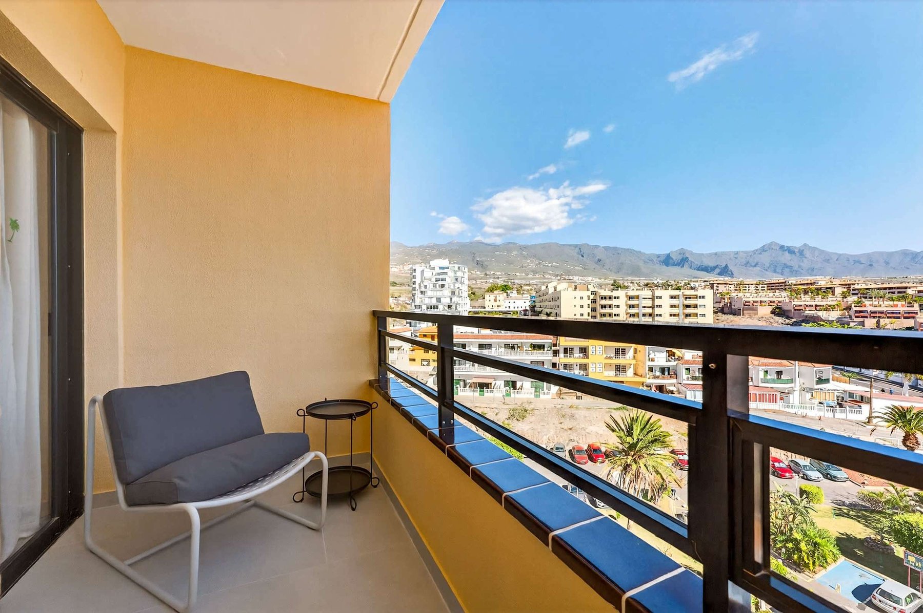 Private Balcony with Scenic Mountain Views, Outdoor Seating & Sunny Atmosphere 