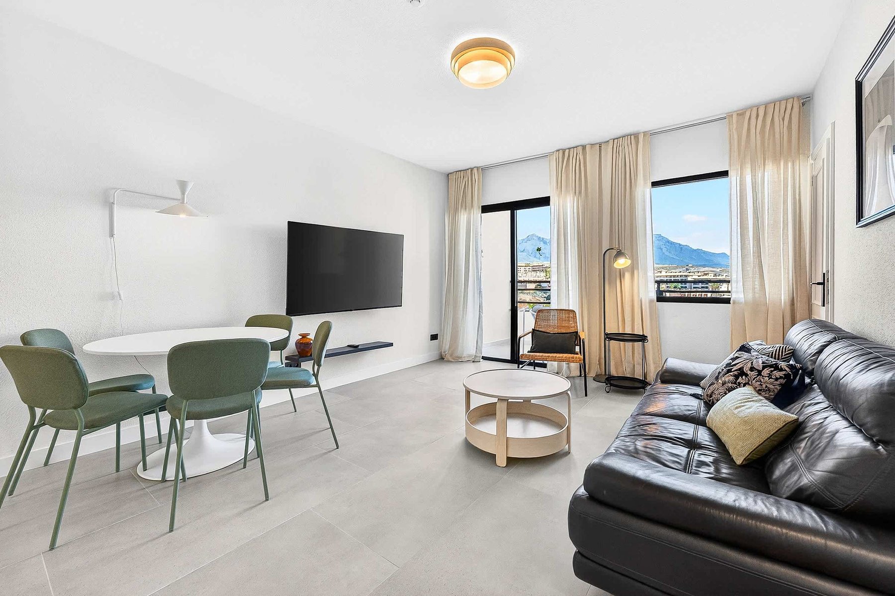Bright Living Room with Balcony Access, Mountain Views & Cozy Seating