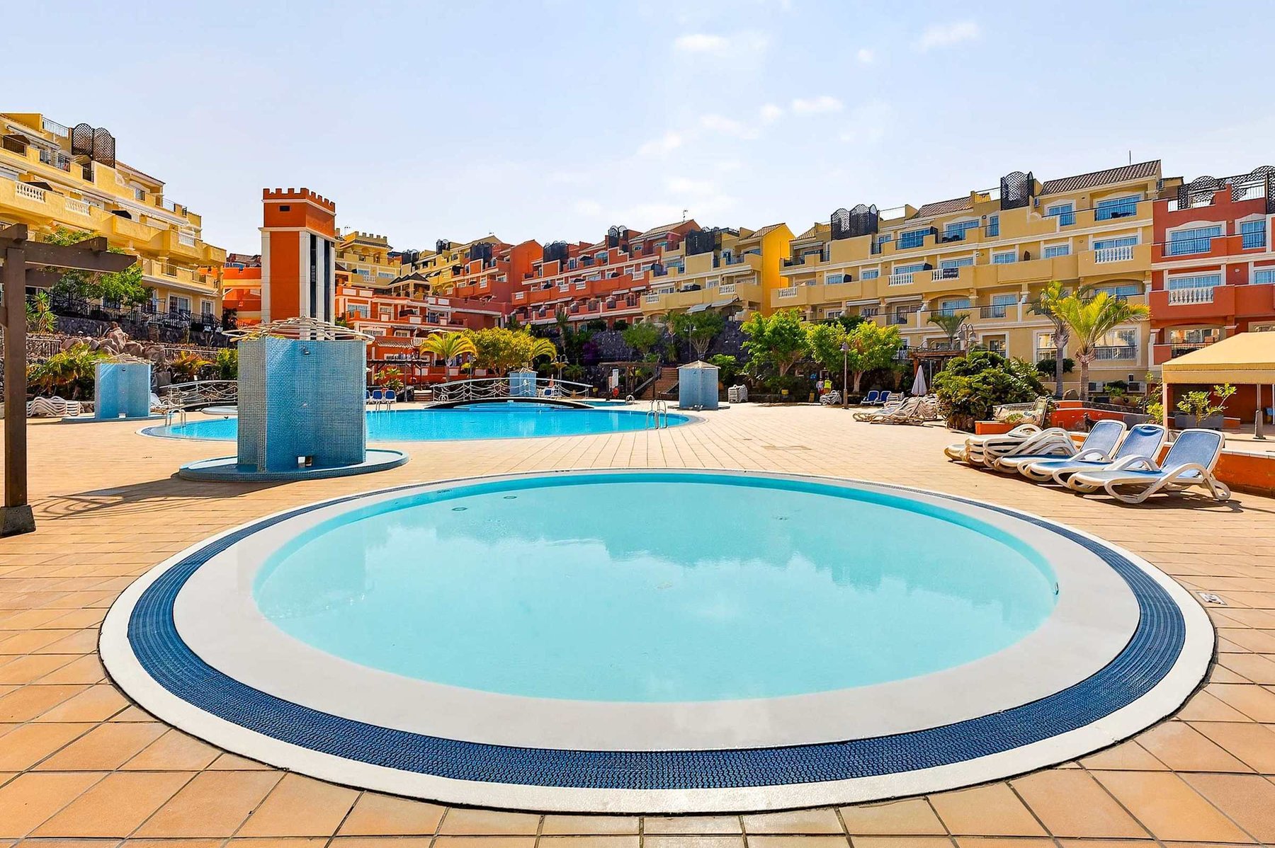 Family-Friendly Pool Area with Sun Loungers and Tropical Surroundings
