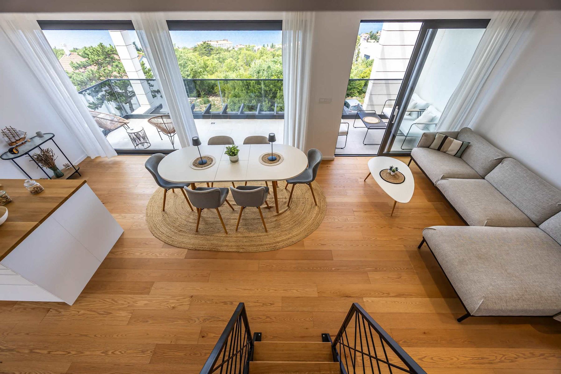 Open-plan living and dining with floor-to-ceiling glass