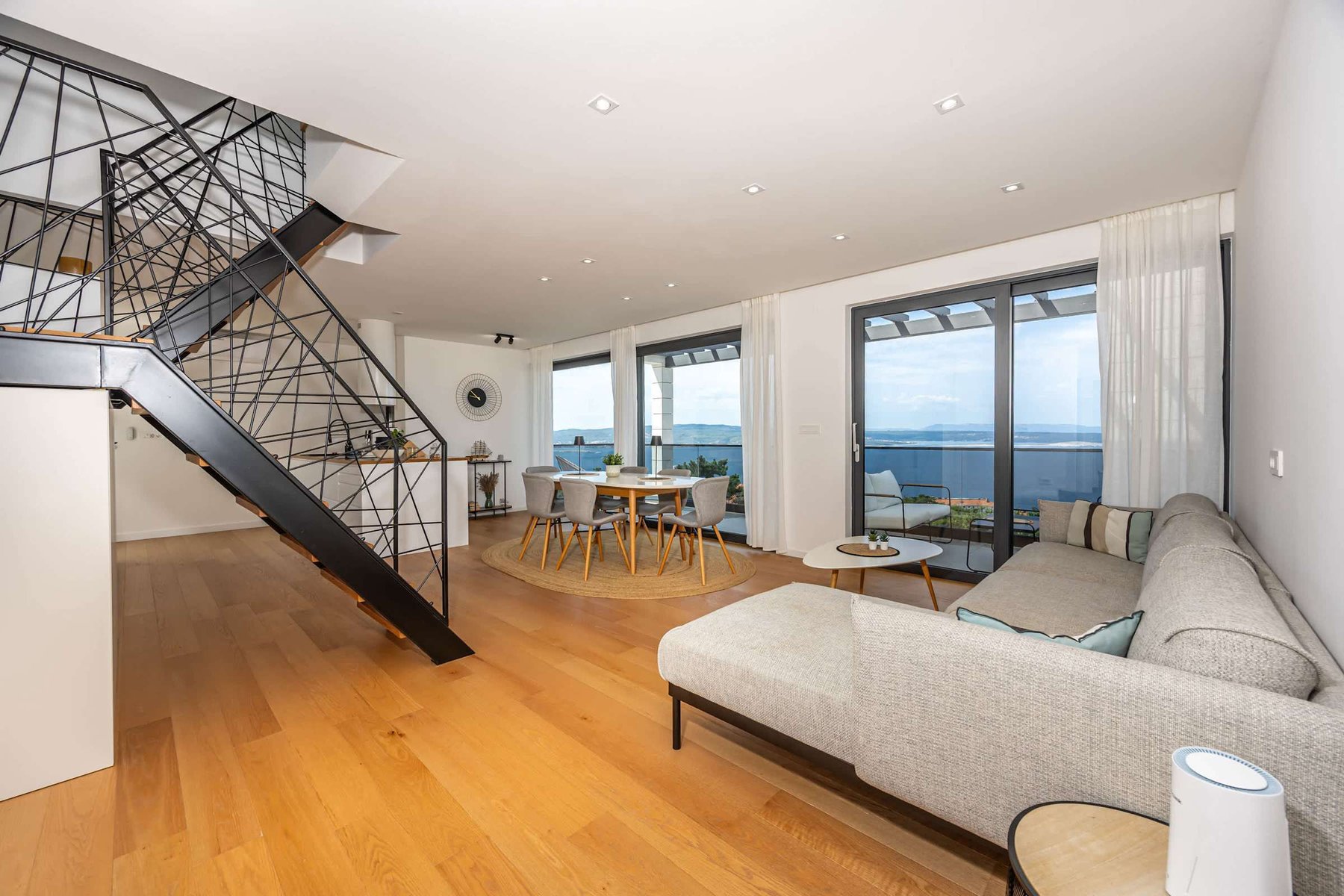 Living Room with Open Staircase to the Upper Level