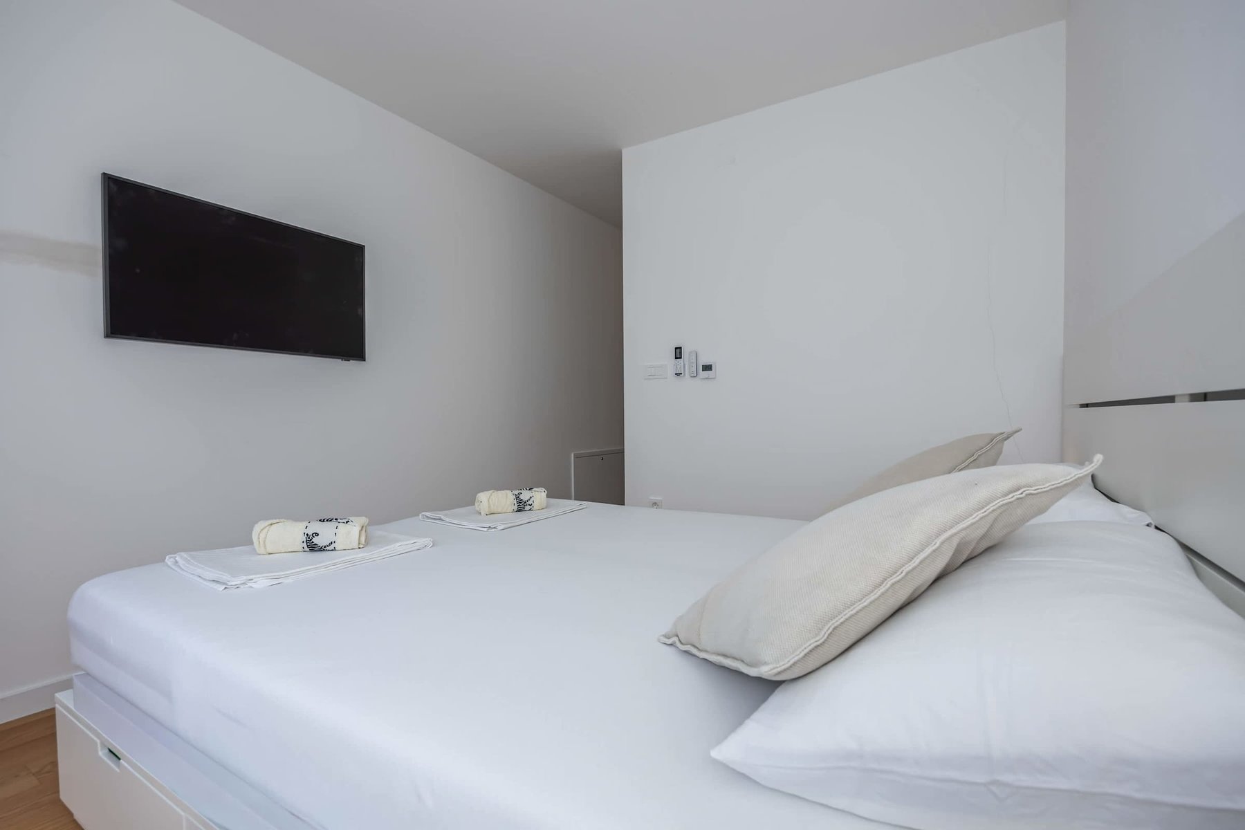 Ground-Level Bedroom with Wall-Mounted TV