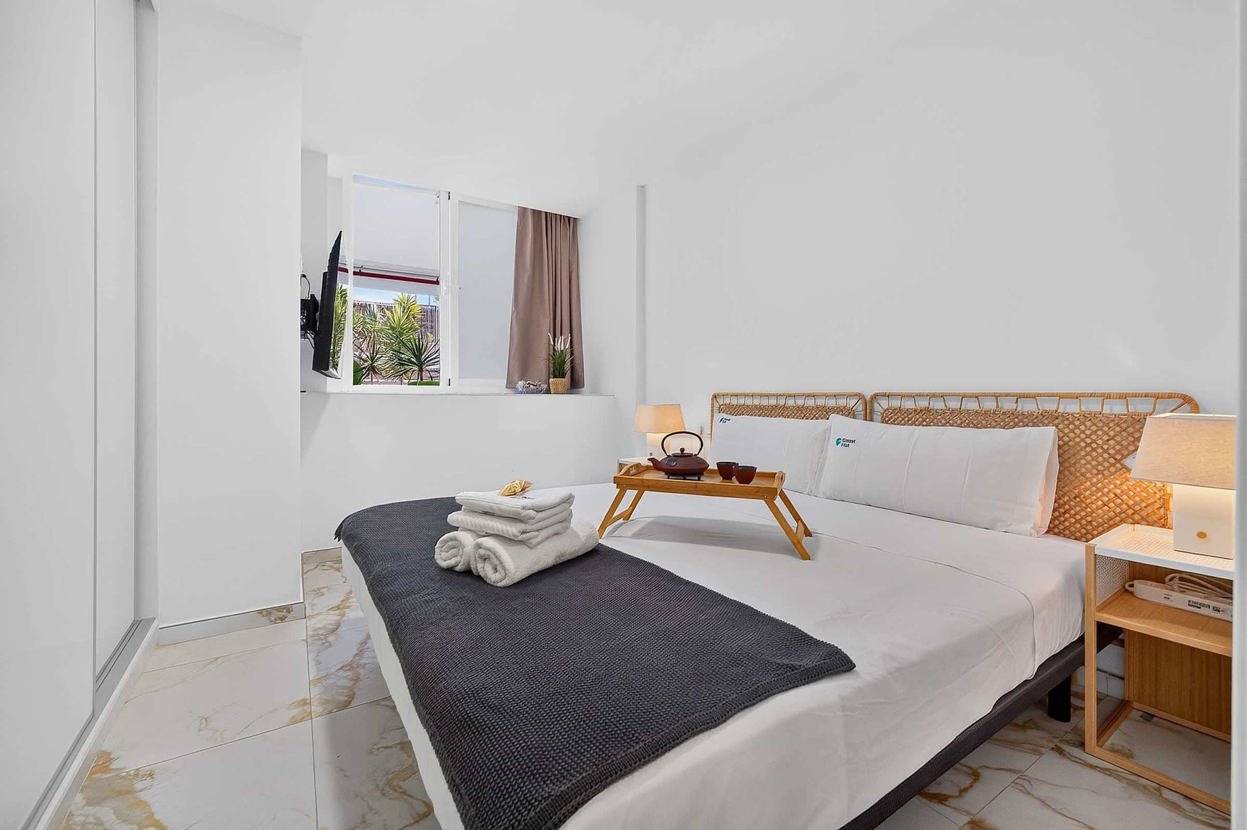 Bedroom with Rattan Headboard & Smart TV