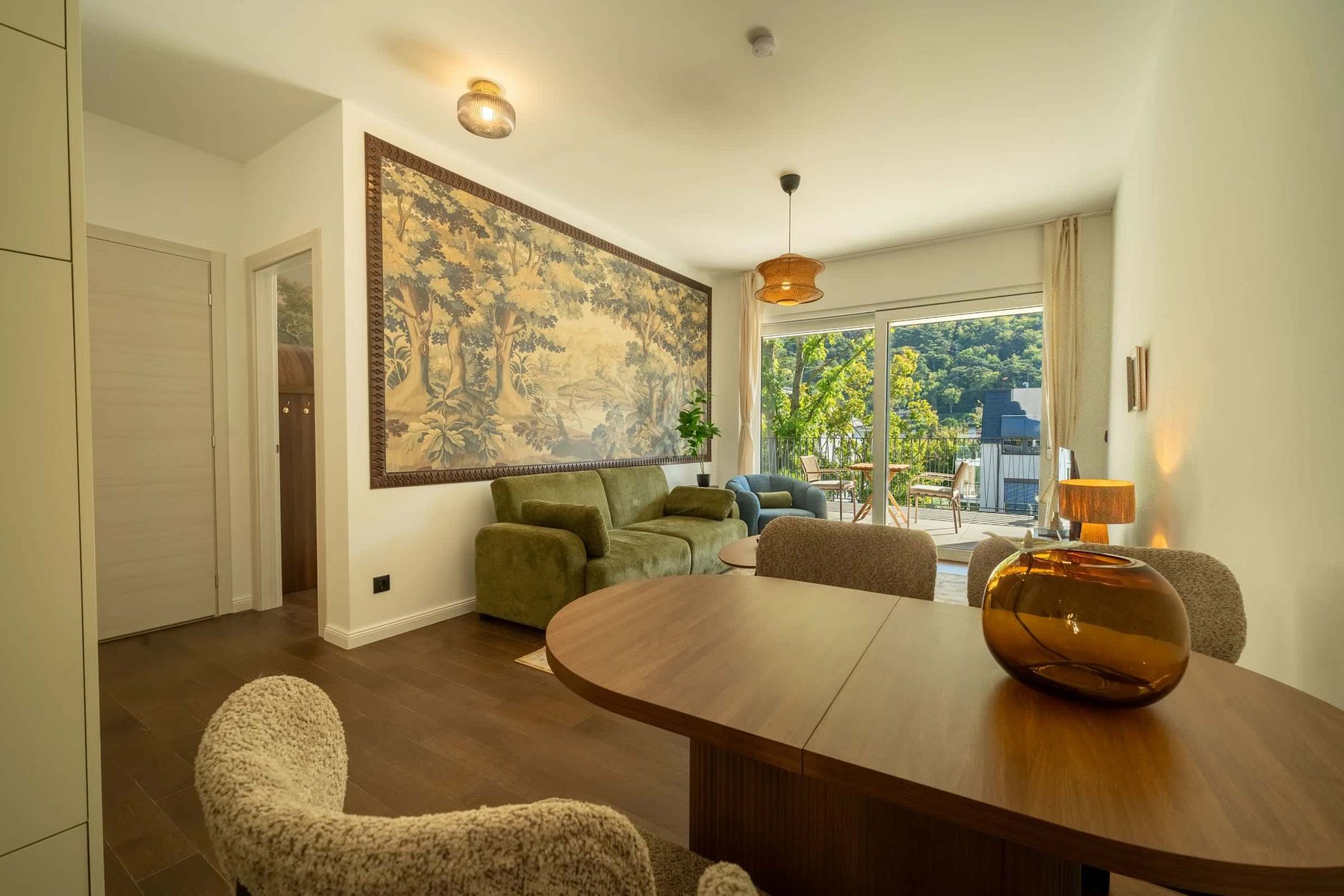 Dining table with the living room and balcony beyond