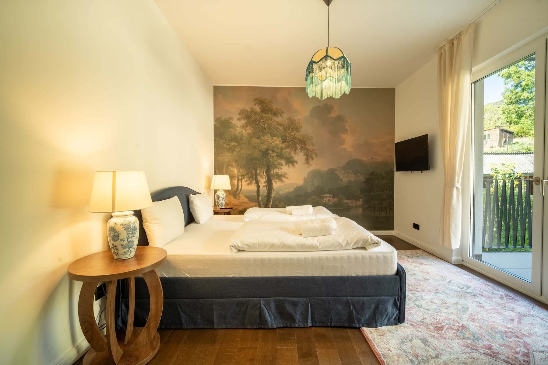 Bedroom 1 with TV and balcony doors