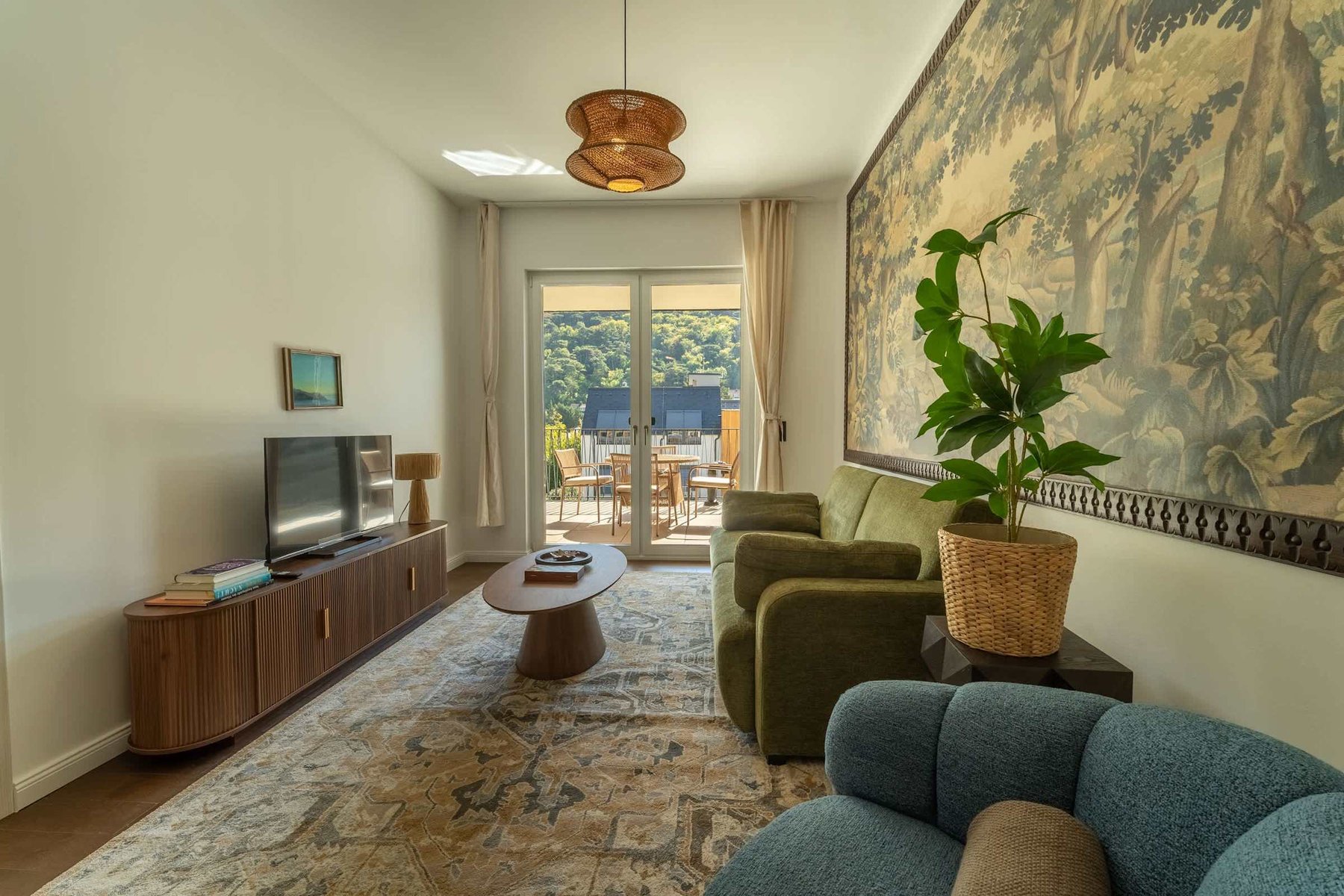 Living area with TV and doors to the balcony