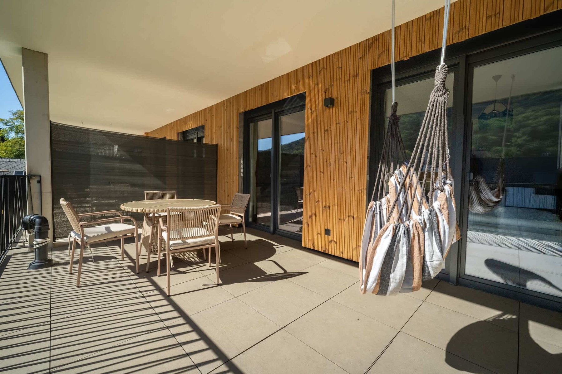 Balcony with hanging chair outside the living room