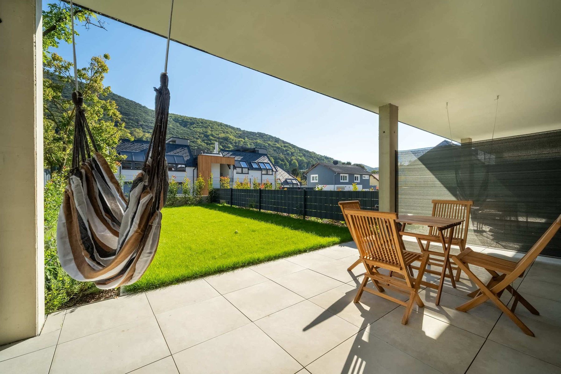 Terrace with hanging chair and dining set