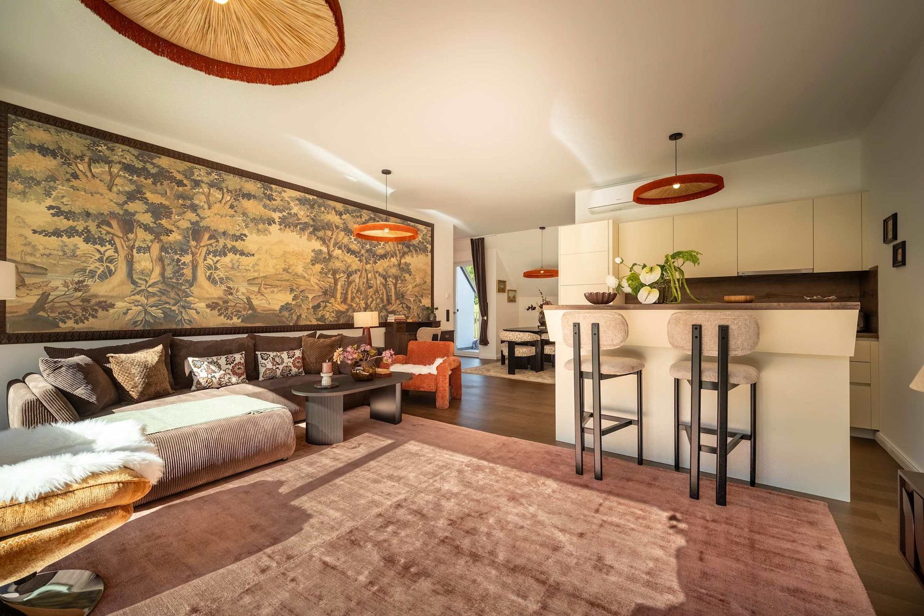 Open-plan living room with corner sofa bed, breakfast bar and kitchen